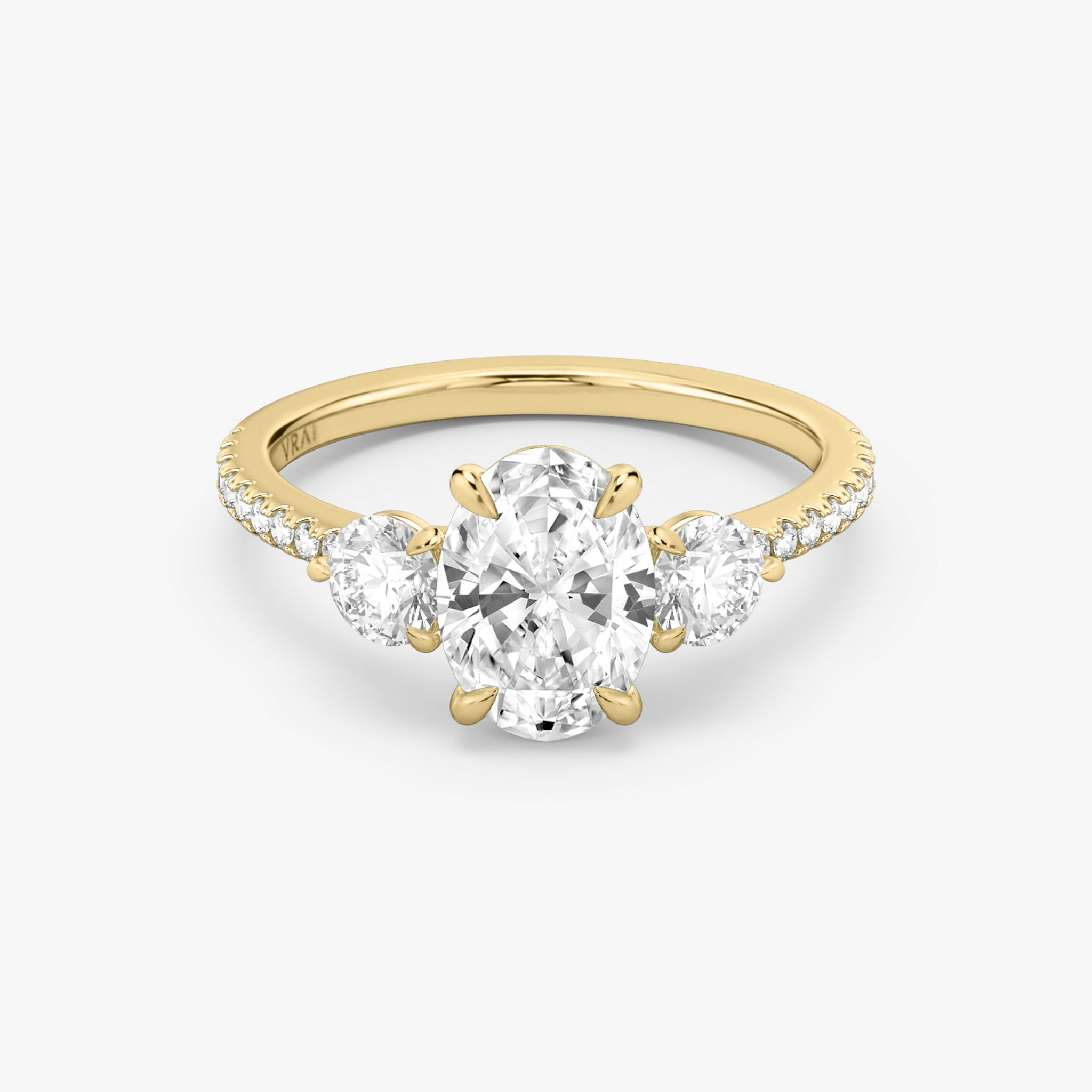 The Three Stone | Oval | 18k | Yellow Gold | bandAccent: Pavé | sideStoneCarat: 0.25ct | sideStoneShape: Round Brilliant | diamondOrientation: vertical | caratWeight: other