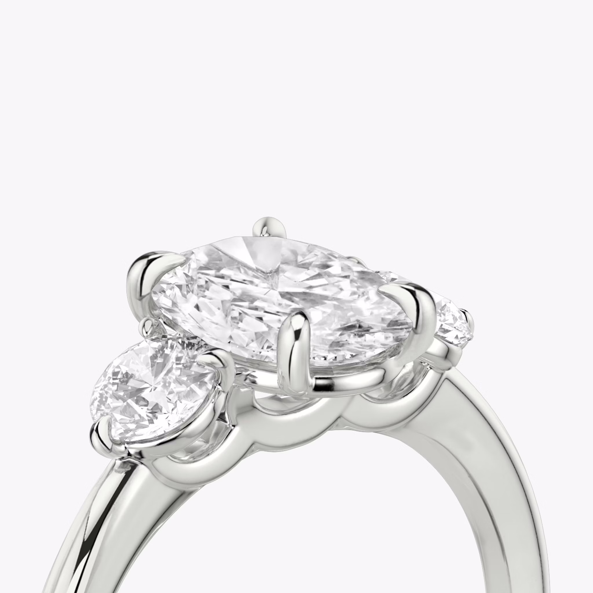 The Three Stone | Oval | 18k | White Gold | bandAccent: Plain | sideStoneCarat: 0.25ct | sideStoneShape: Round Brilliant | diamondOrientation: vertical | caratWeight: other