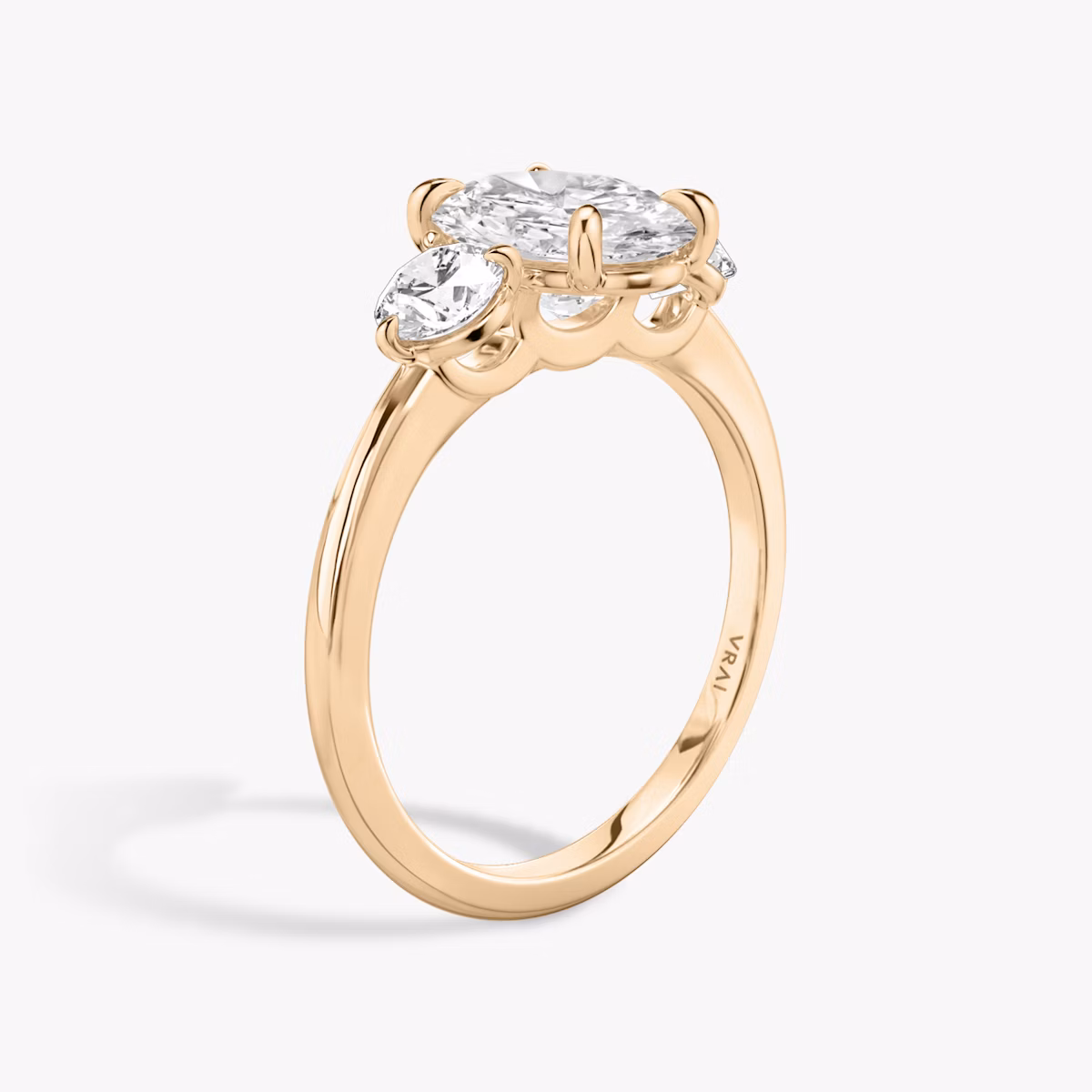The Three Stone | Oval | 14k | Rose Gold | bandAccent: Plain | sideStoneCarat: 0.25ct | sideStoneShape: Round Brilliant | diamondOrientation: vertical | caratWeight: other