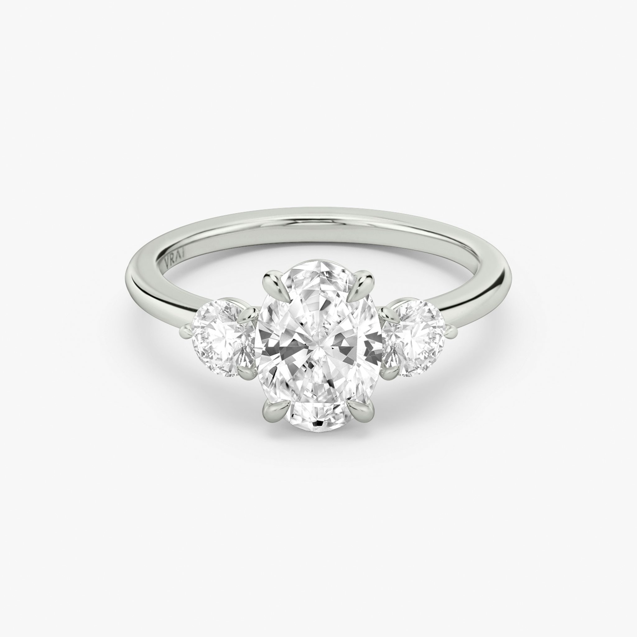 The Three Stone | Oval | 18k | White Gold | bandAccent: Plain | sideStoneCarat: 0.25ct | sideStoneShape: Round Brilliant | diamondOrientation: vertical | caratWeight: other