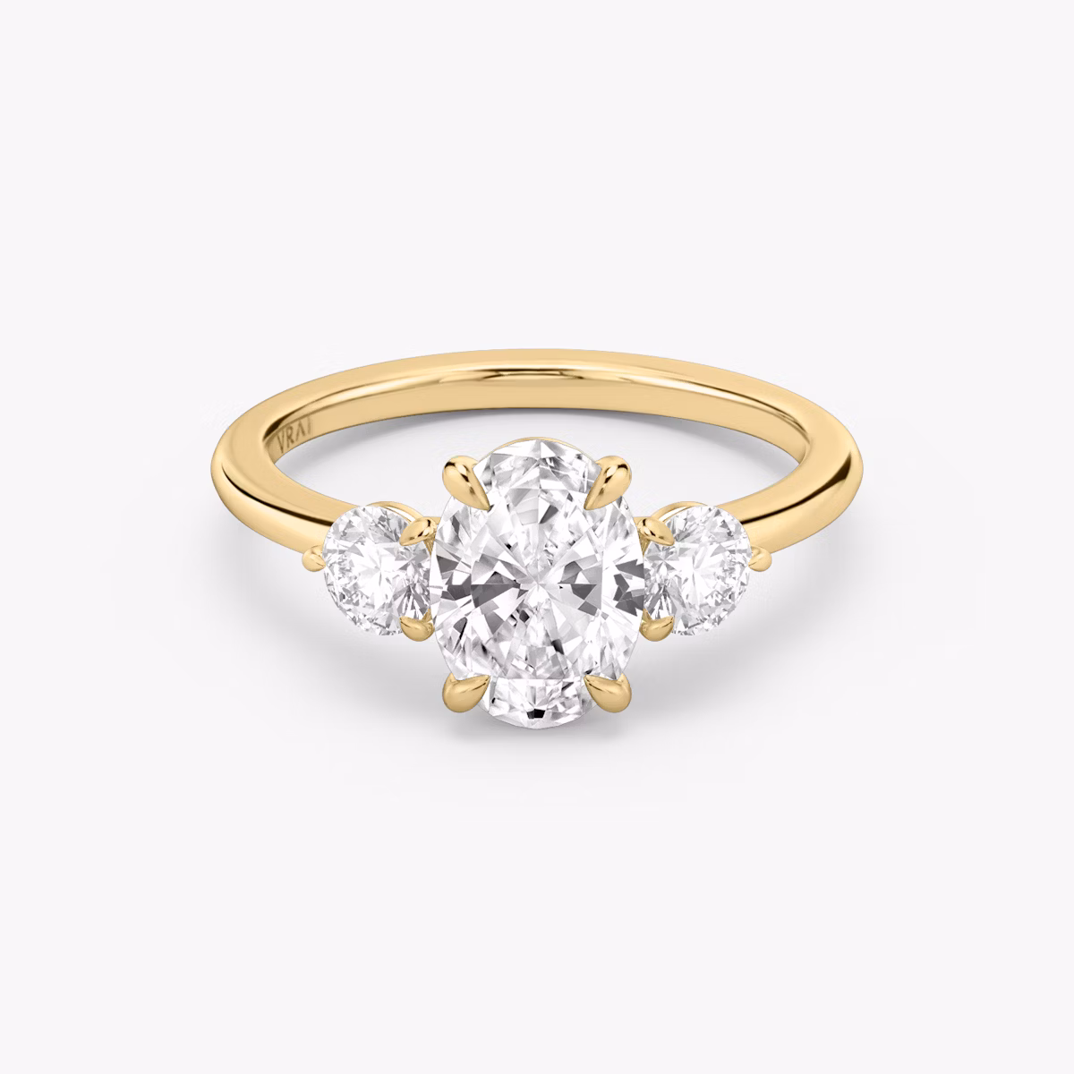 The Three Stone | Oval | 18k | Yellow Gold | bandAccent: Plain | sideStoneCarat: 0.25ct | sideStoneShape: Round Brilliant | diamondOrientation: vertical | caratWeight: other