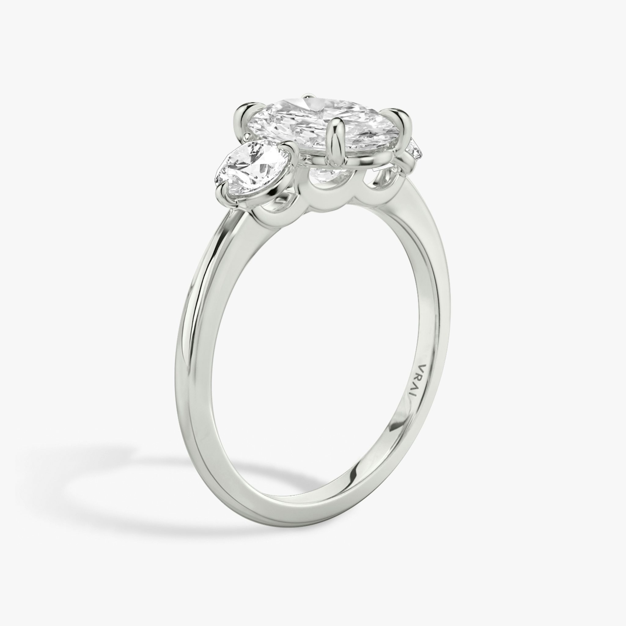 The Three Stone | Oval | 18k | White Gold | bandAccent: Plain | sideStoneCarat: 0.25ct | sideStoneShape: Round Brilliant | diamondOrientation: vertical | caratWeight: other