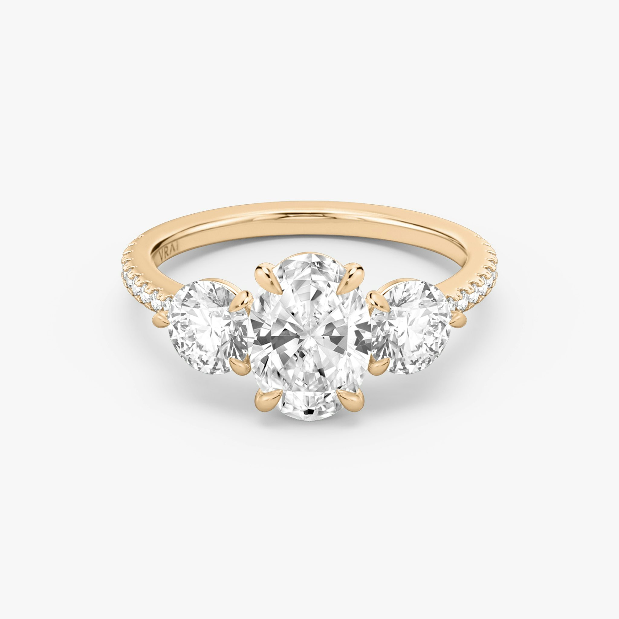 The Three Stone | Oval | 14k | Rose Gold | bandAccent: Pavé | sideStoneCarat: 0.50ct | sideStoneShape: Round Brilliant | diamondOrientation: vertical | caratWeight: other