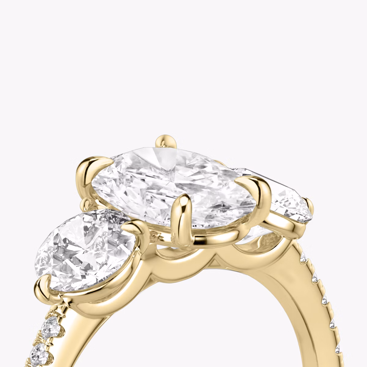 The Three Stone | Oval | 18k | Yellow Gold | bandAccent: Pavé | sideStoneCarat: 0.50ct | sideStoneShape: Round Brilliant | diamondOrientation: vertical | caratWeight: other