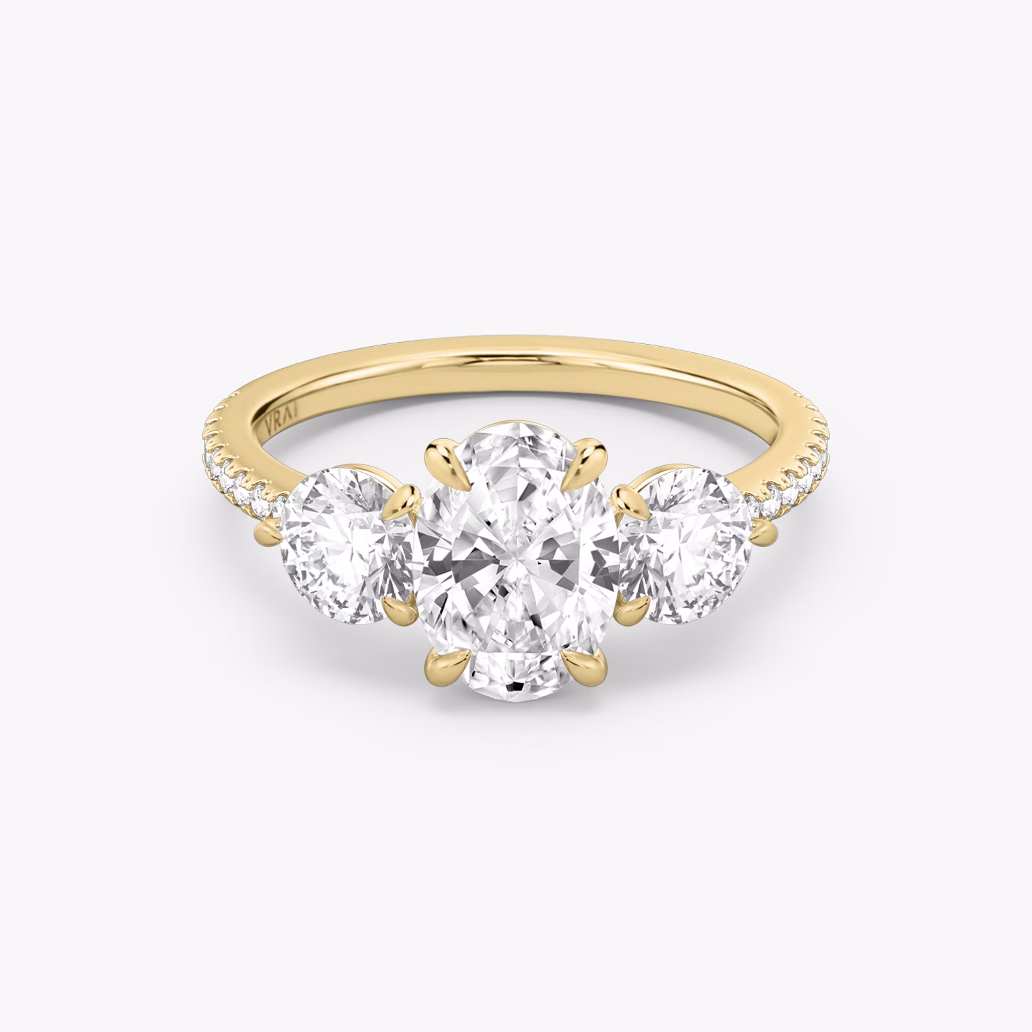 The Three Stone | Oval | 18k | Yellow Gold | bandAccent: Pavé | sideStoneCarat: 0.50ct | sideStoneShape: Round Brilliant | diamondOrientation: vertical | caratWeight: other