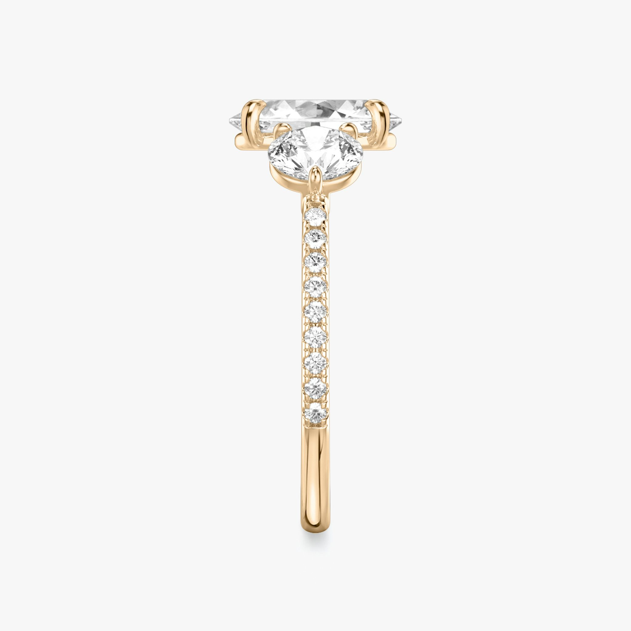 The Three Stone | Oval | 14k | Rose Gold | bandAccent: Pavé | sideStoneCarat: 0.50ct | sideStoneShape: Round Brilliant | diamondOrientation: vertical | caratWeight: other
