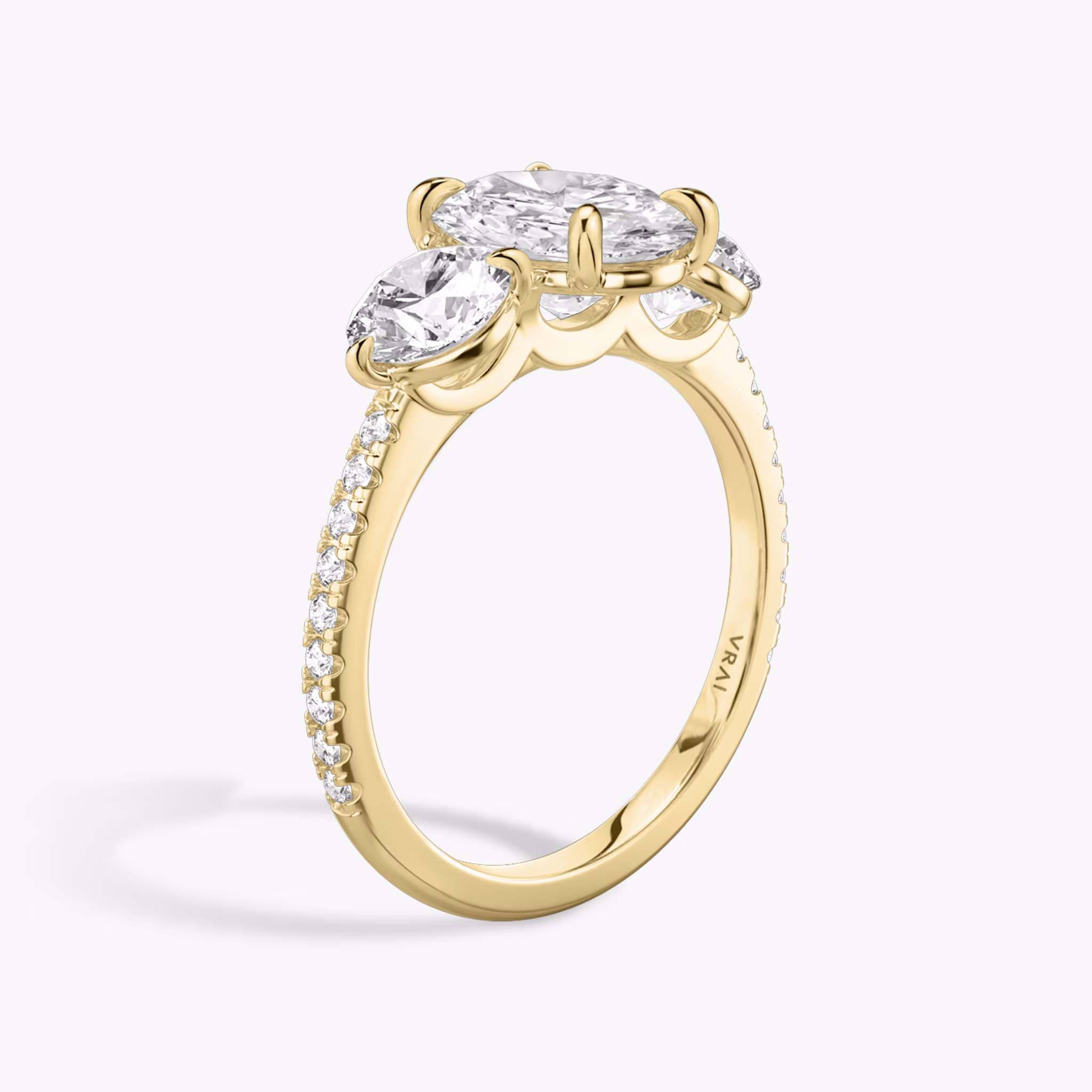 The Three Stone | Oval | 18k | Yellow Gold | bandAccent: Pavé | sideStoneCarat: 0.50ct | sideStoneShape: Round Brilliant | diamondOrientation: vertical | caratWeight: other