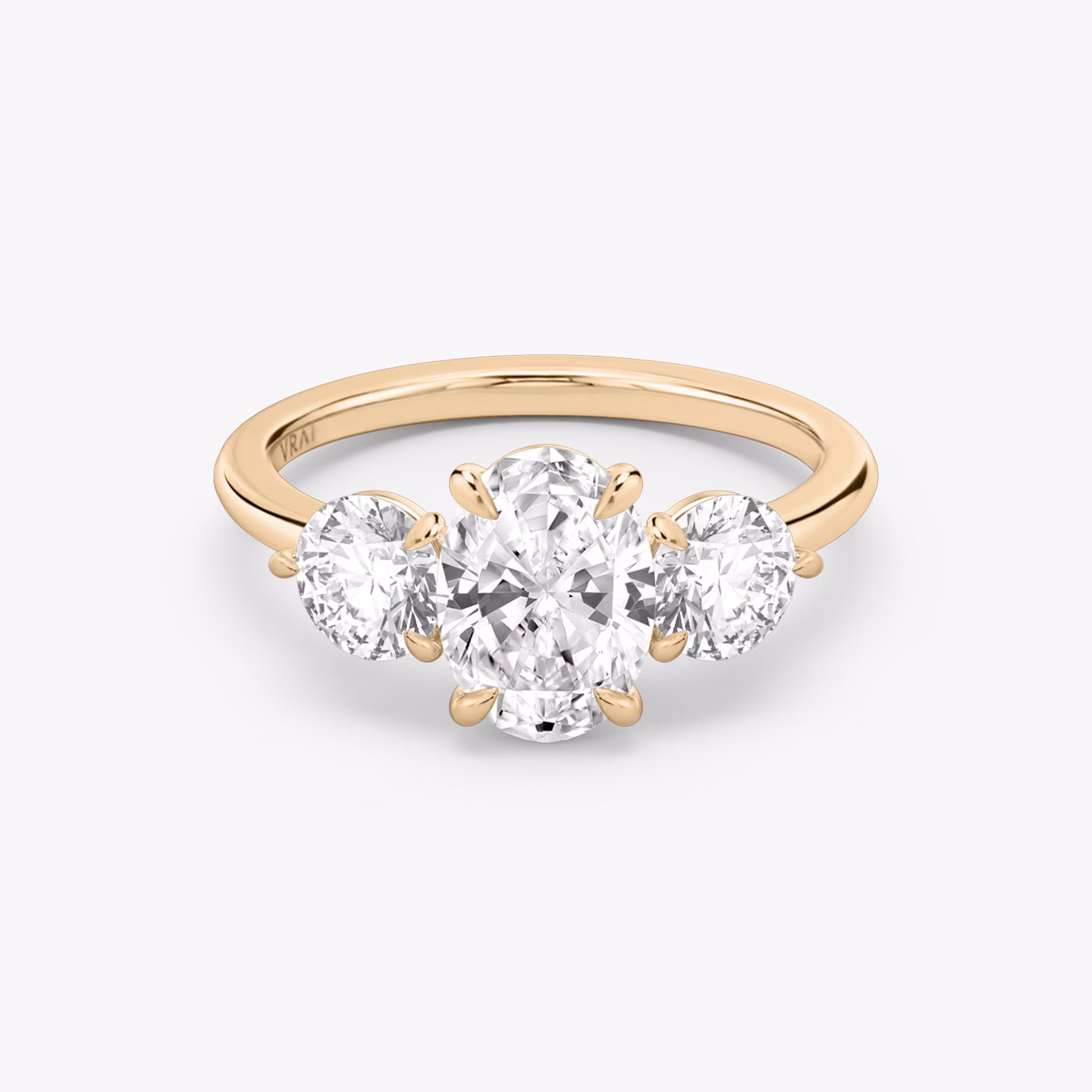 The Three Stone | Oval | 14k | Rose Gold | bandAccent: Plain | sideStoneCarat: 0.50ct | sideStoneShape: Round Brilliant | diamondOrientation: vertical | caratWeight: other
