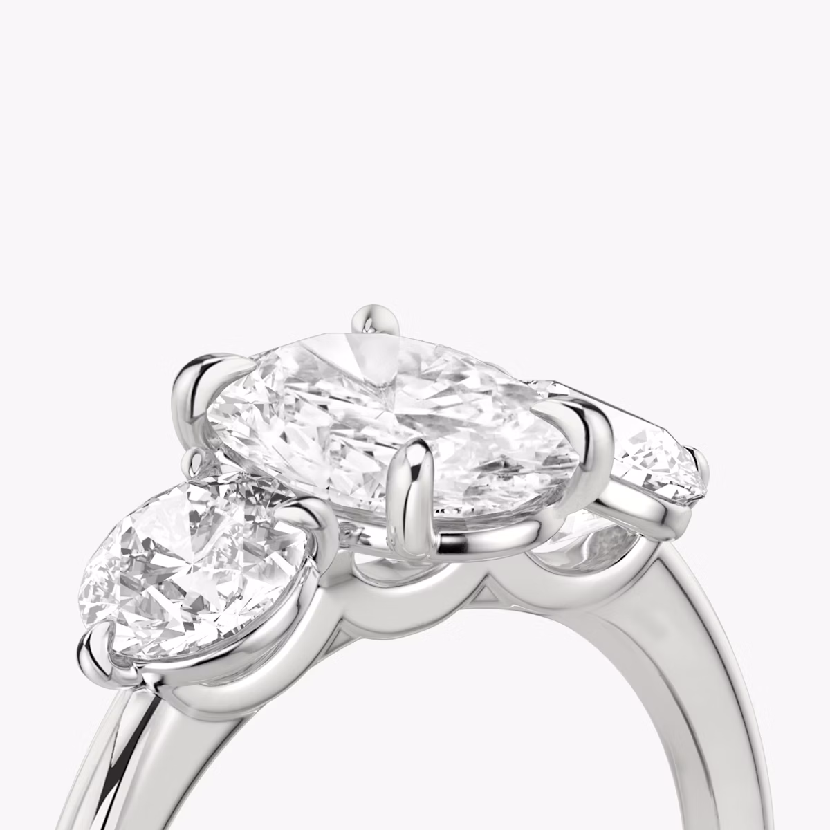 The Three Stone | Oval | Platinum | bandAccent: Plain | sideStoneCarat: 0.50ct | sideStoneShape: Round Brilliant | diamondOrientation: vertical | caratWeight: other