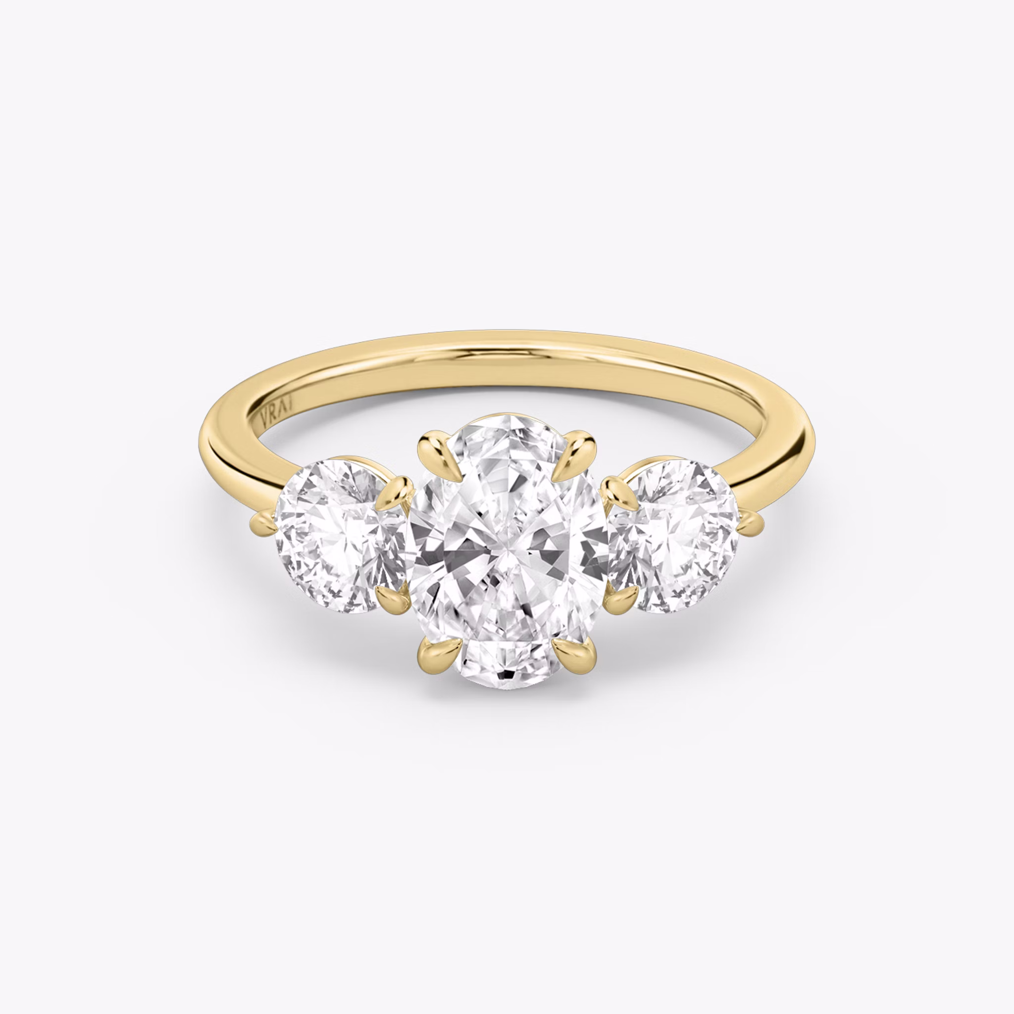 The Three Stone | Oval | 18k | Yellow Gold | bandAccent: Plain | sideStoneCarat: 0.50ct | sideStoneShape: Round Brilliant | diamondOrientation: vertical | caratWeight: other