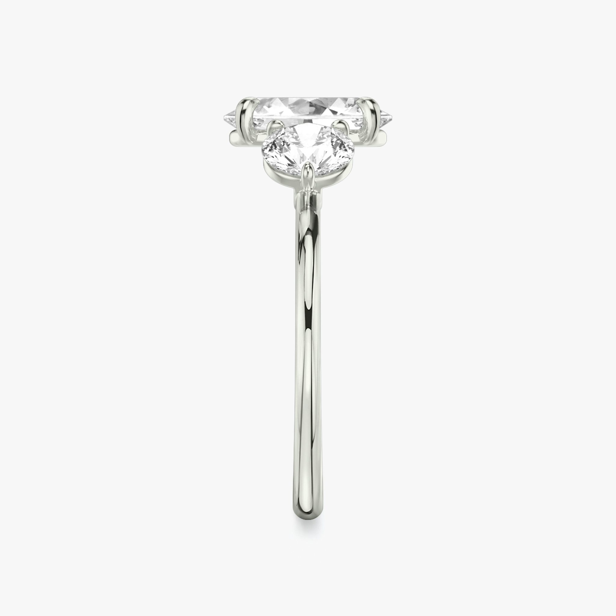 The Three Stone | Oval | 18k | White Gold | bandAccent: Plain | sideStoneCarat: 0.50ct | sideStoneShape: Round Brilliant | diamondOrientation: vertical | caratWeight: other