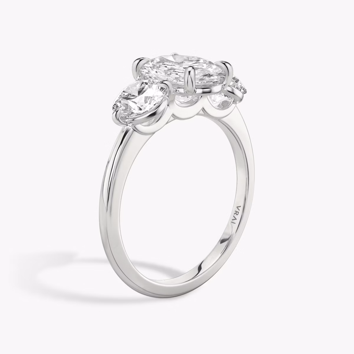 The Three Stone | Oval | Platinum | bandAccent: Plain | sideStoneCarat: 0.50ct | sideStoneShape: Round Brilliant | diamondOrientation: vertical | caratWeight: other