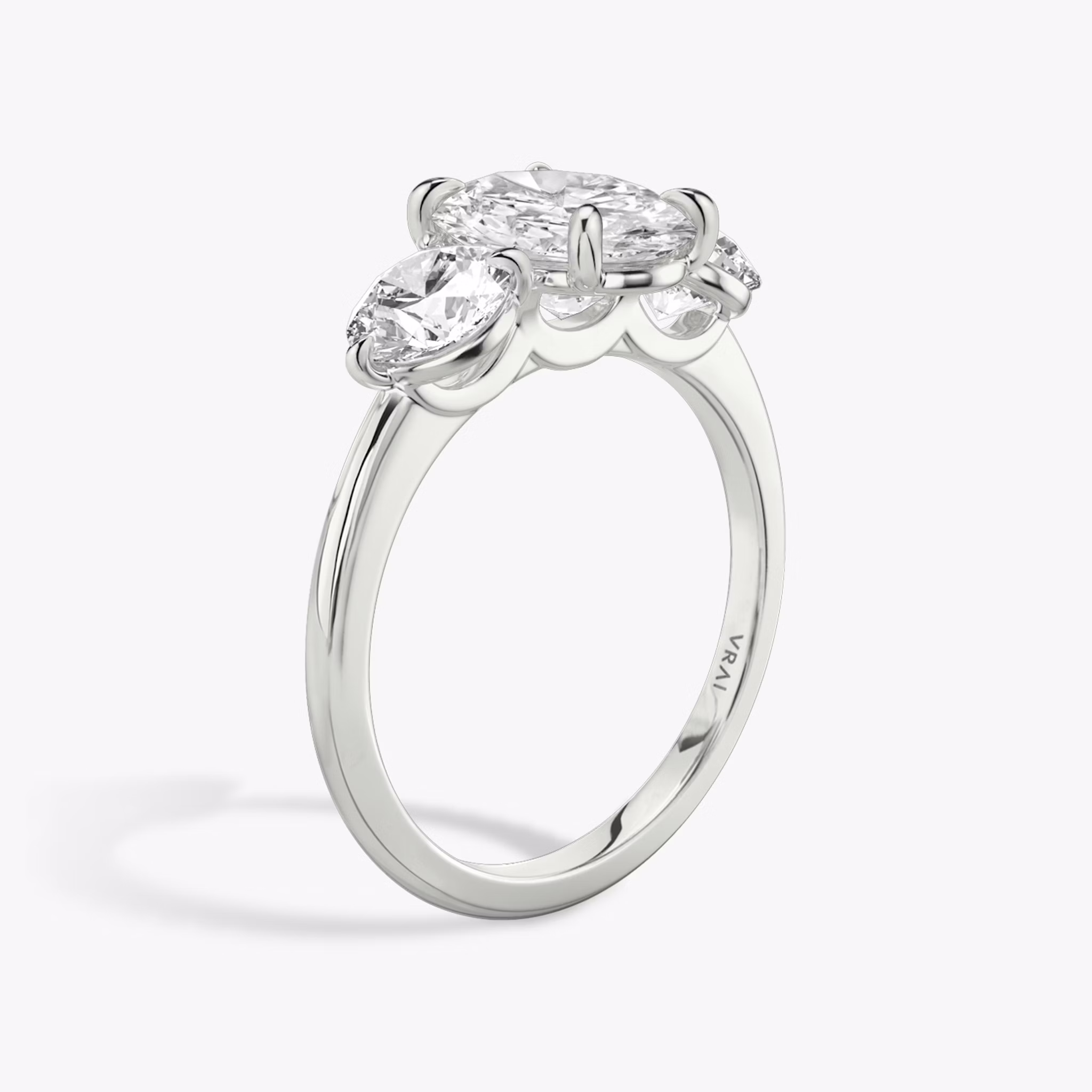 The Three Stone | Oval | 18k | White Gold | bandAccent: Plain | sideStoneCarat: 0.50ct | sideStoneShape: Round Brilliant | diamondOrientation: vertical | caratWeight: other