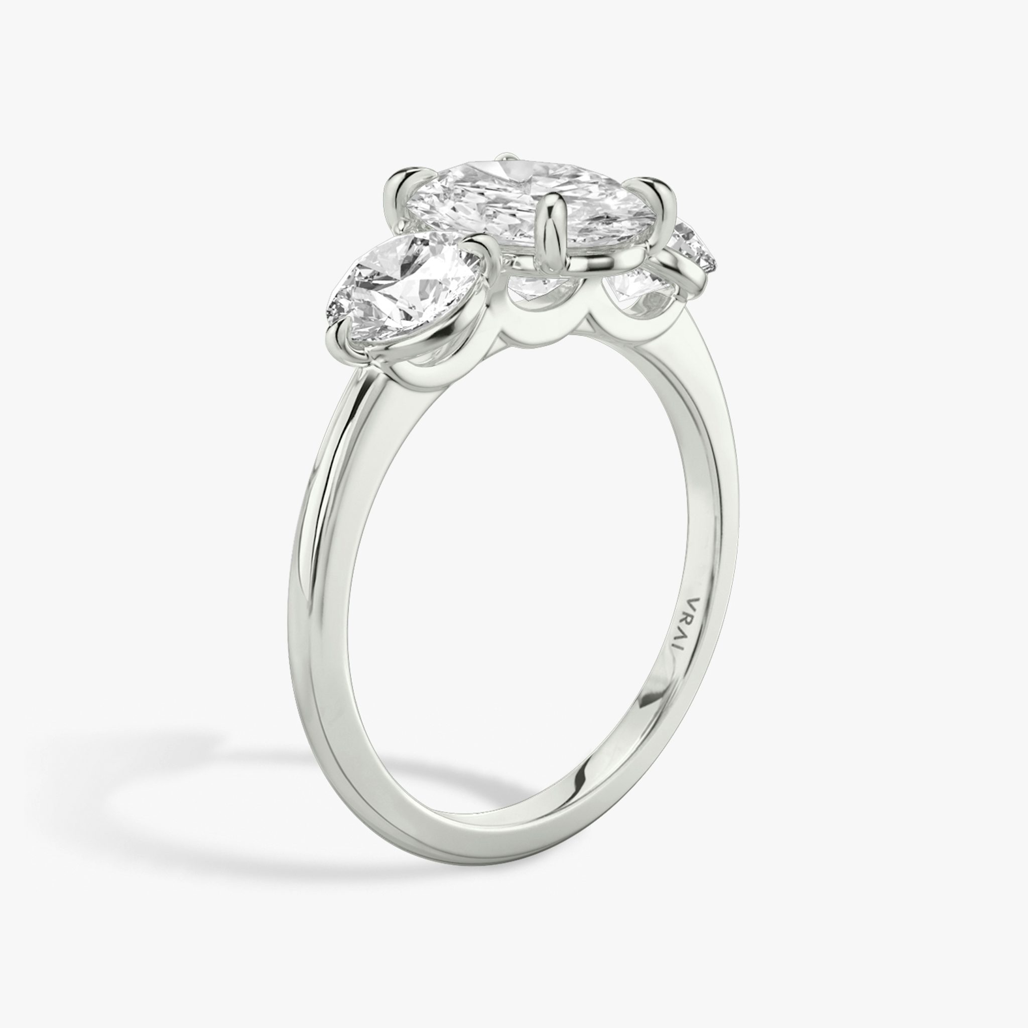 The Three Stone | Oval | 18k | White Gold | bandAccent: Plain | sideStoneCarat: 0.50ct | sideStoneShape: Round Brilliant | diamondOrientation: vertical | caratWeight: other