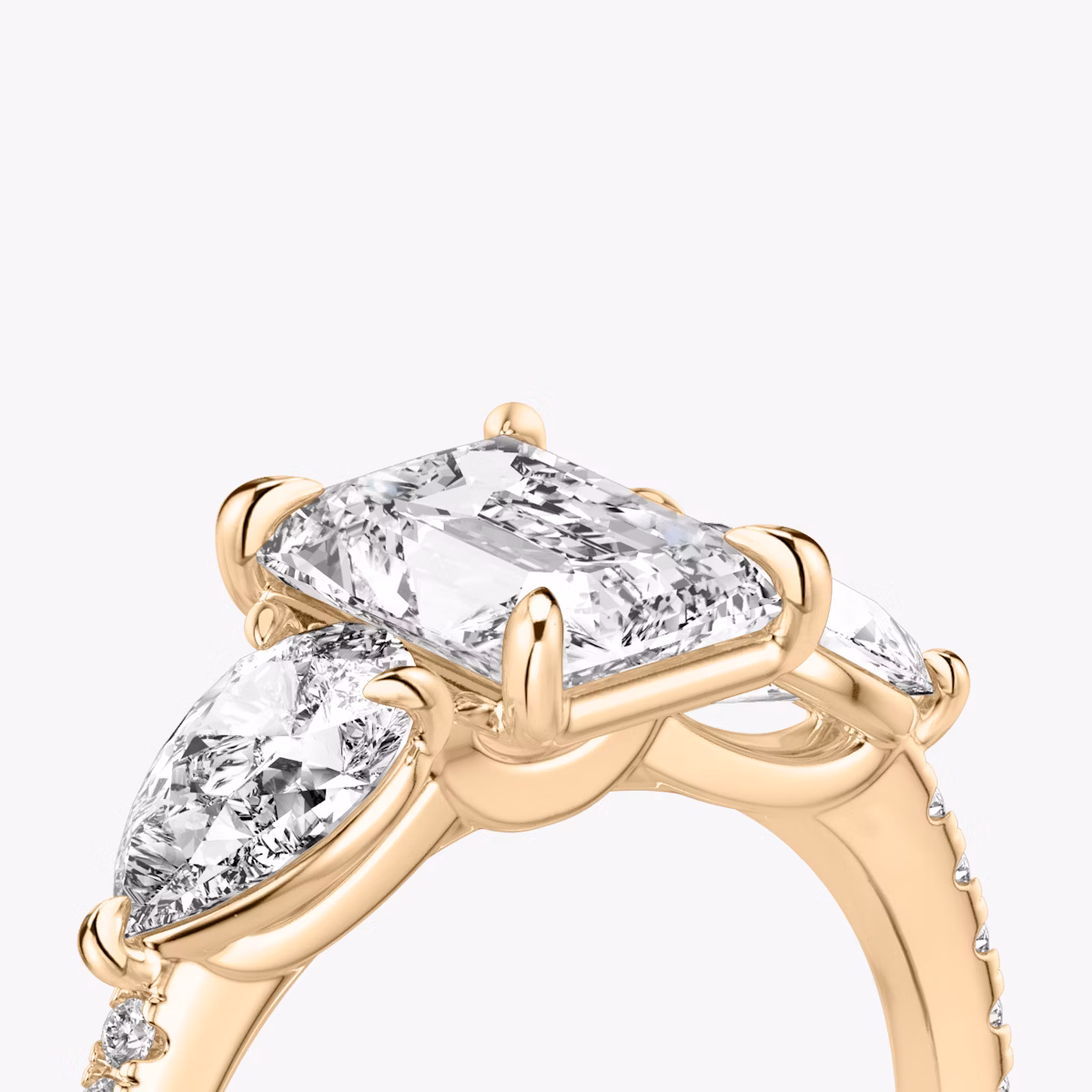 The Three Stone | Radiant | 14k | Rose Gold | bandAccent: Pavé | sideStoneCarat: 0.50ct | sideStoneShape: Pear | diamondOrientation: vertical | caratWeight: other