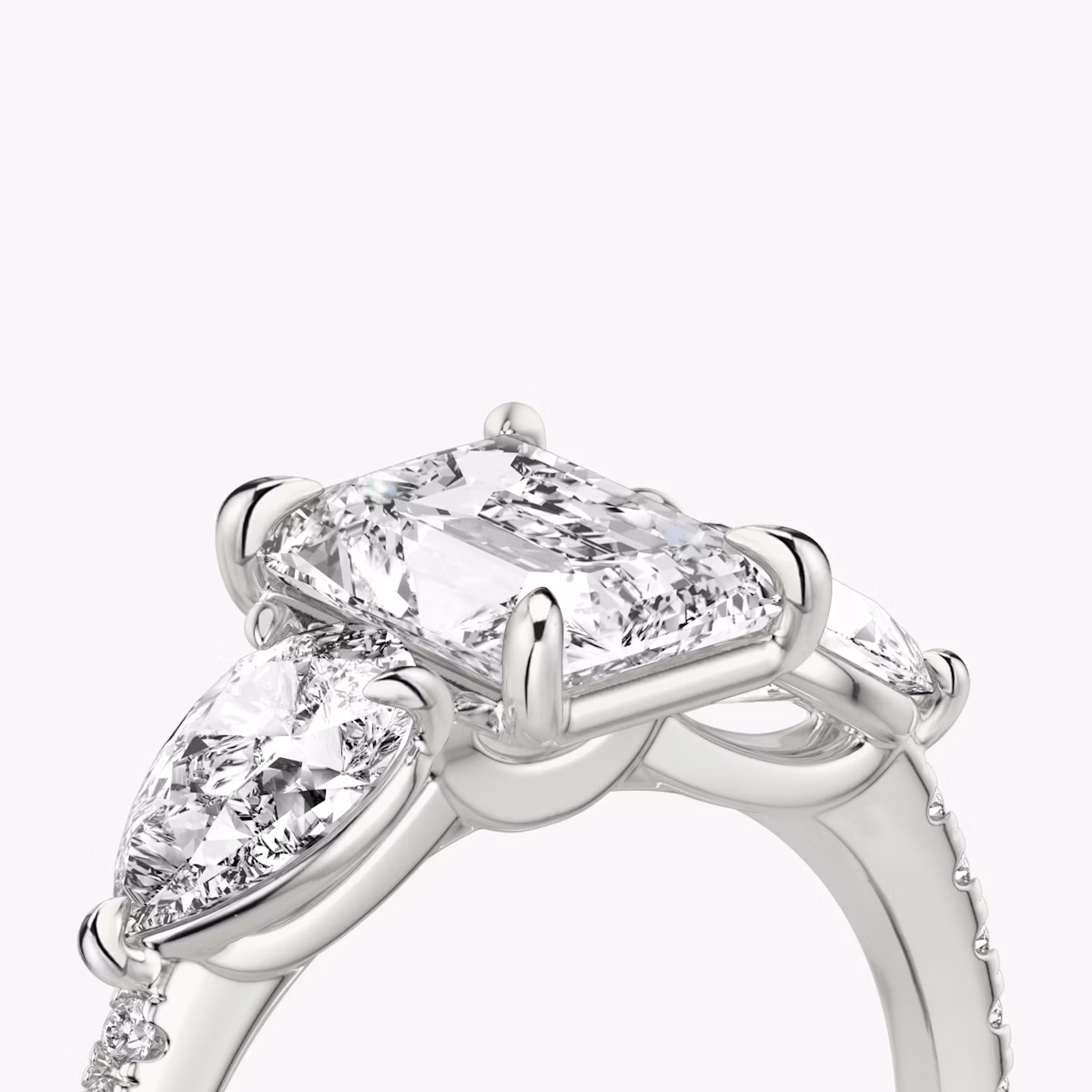 The Three Stone | Radiant | Platinum | bandAccent: Pavé | sideStoneCarat: 0.50ct | sideStoneShape: Pear | diamondOrientation: vertical | caratWeight: other