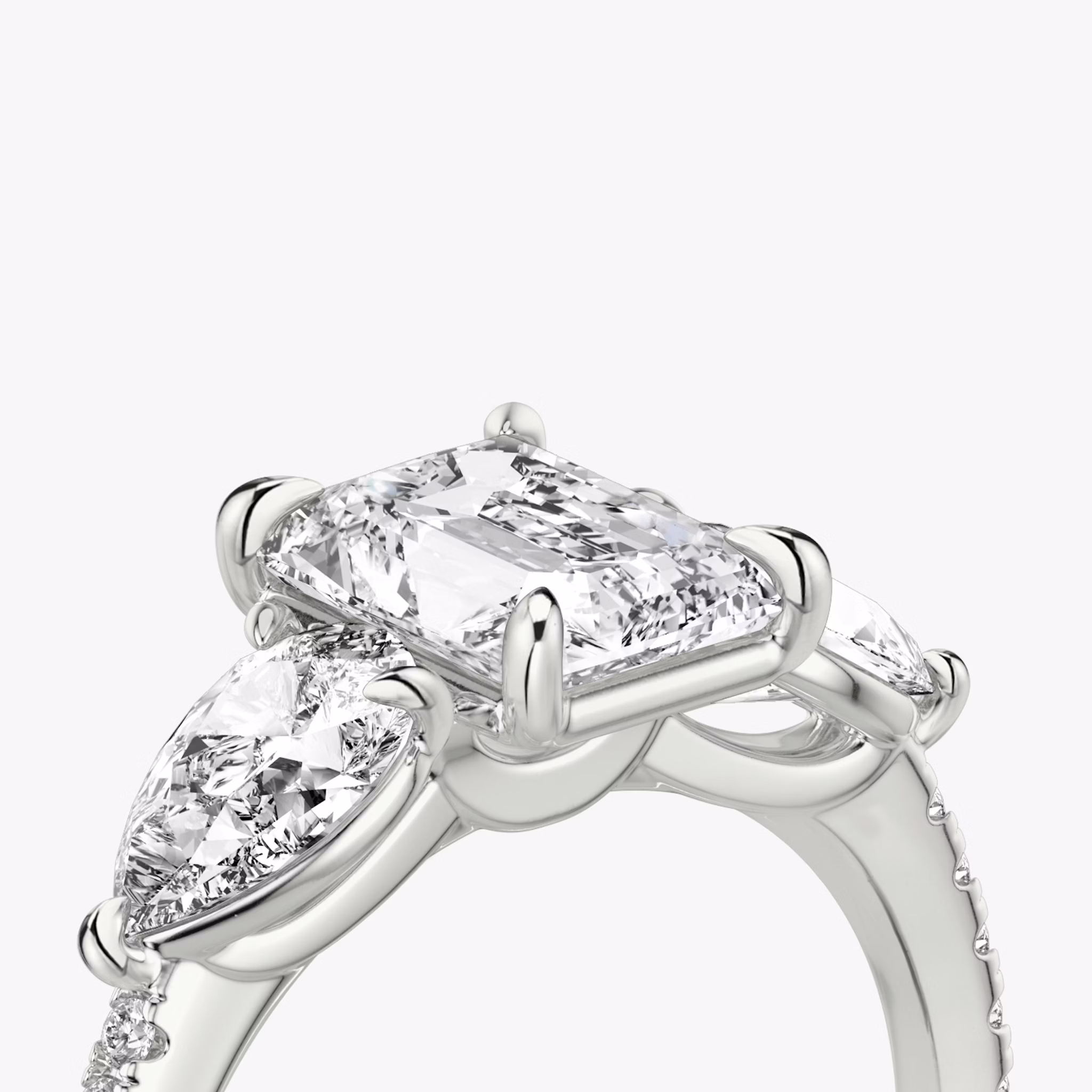 The Three Stone | Radiant | 18k | White Gold | bandAccent: Pavé | sideStoneCarat: 0.50ct | sideStoneShape: Pear | diamondOrientation: vertical | caratWeight: other