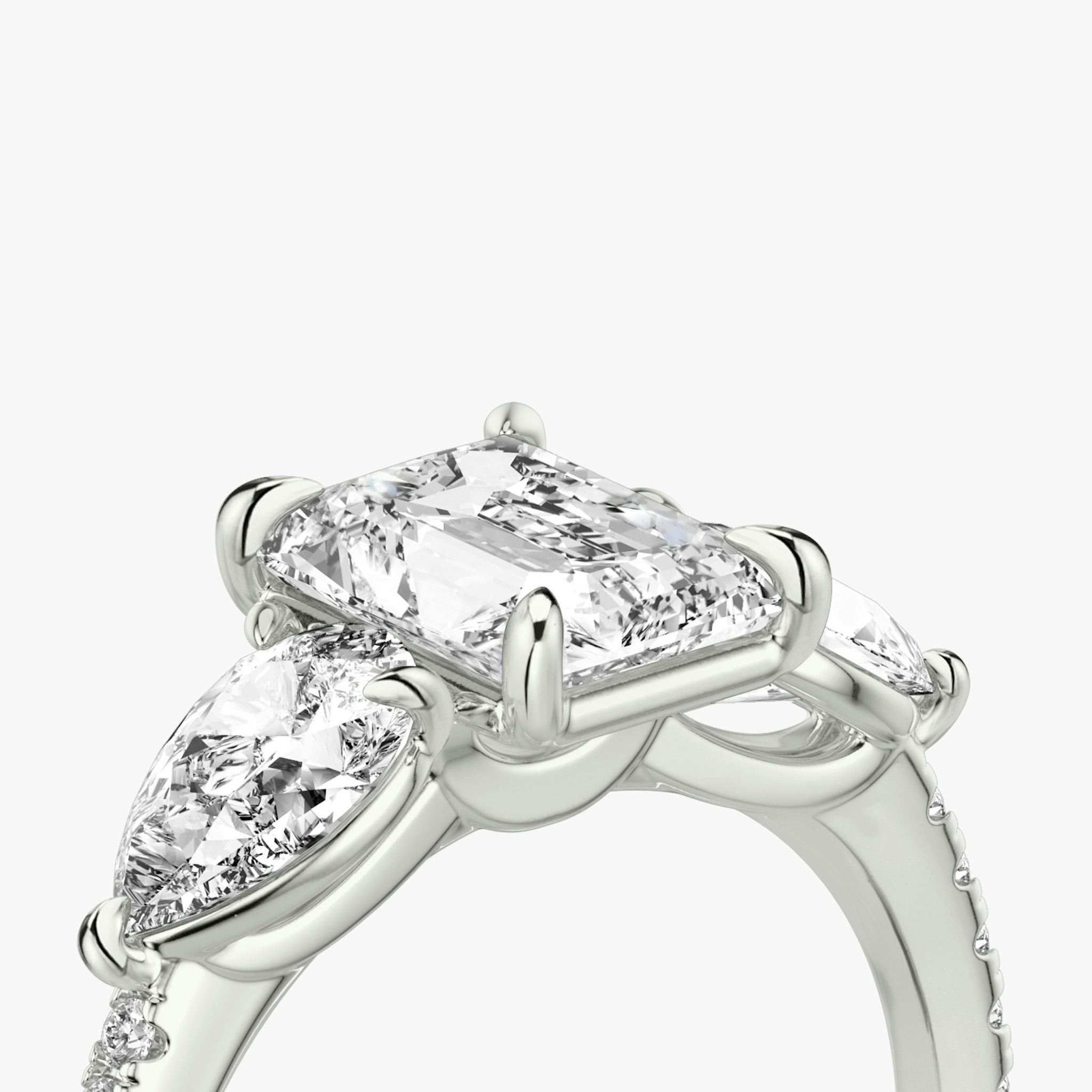 The Three Stone | Radiant | 18k | White Gold | bandAccent: Pavé | sideStoneCarat: 0.50ct | sideStoneShape: Pear | diamondOrientation: vertical | caratWeight: other