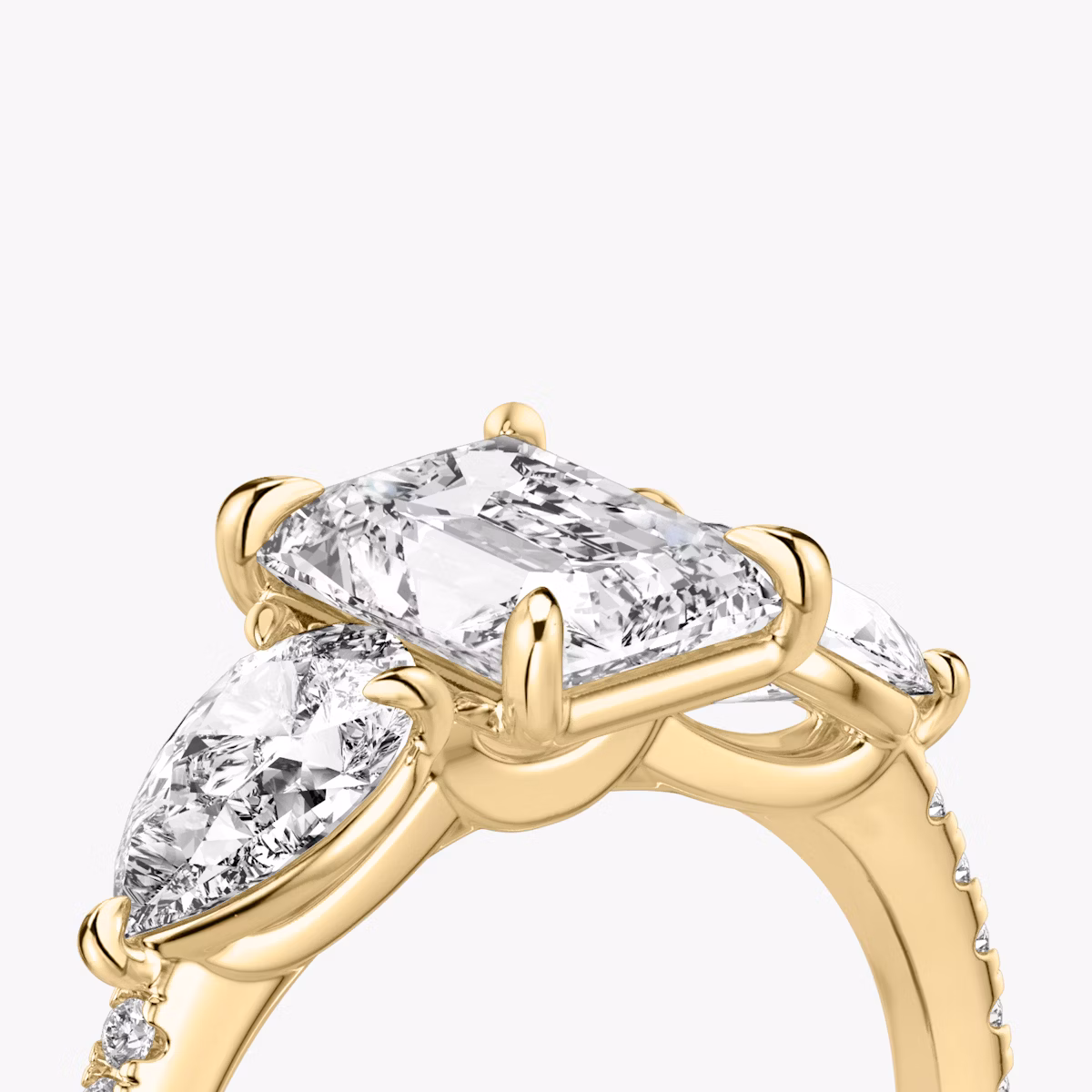 The Three Stone | Radiant | 18k | Yellow Gold | bandAccent: Pavé | sideStoneCarat: 0.50ct | sideStoneShape: Pear | diamondOrientation: vertical | caratWeight: other