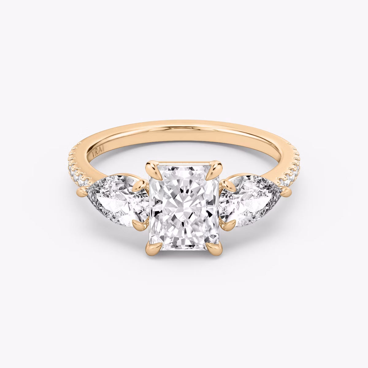 The Three Stone | Radiant | 14k | Rose Gold | bandAccent: Pavé | sideStoneCarat: 0.50ct | sideStoneShape: Pear | diamondOrientation: vertical | caratWeight: other