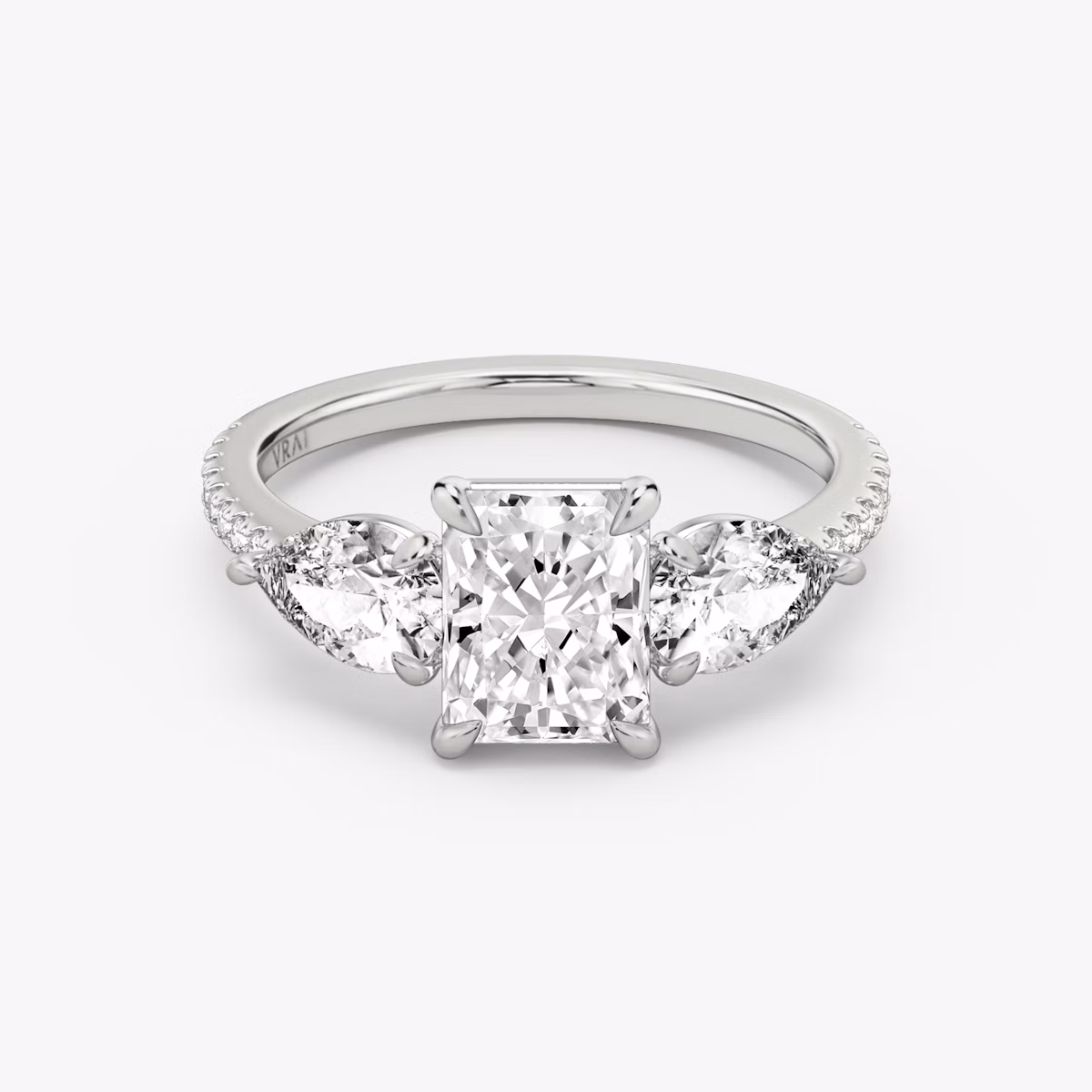 The Three Stone | Radiant | Platinum | bandAccent: Pavé | sideStoneCarat: 0.50ct | sideStoneShape: Pear | diamondOrientation: vertical | caratWeight: other