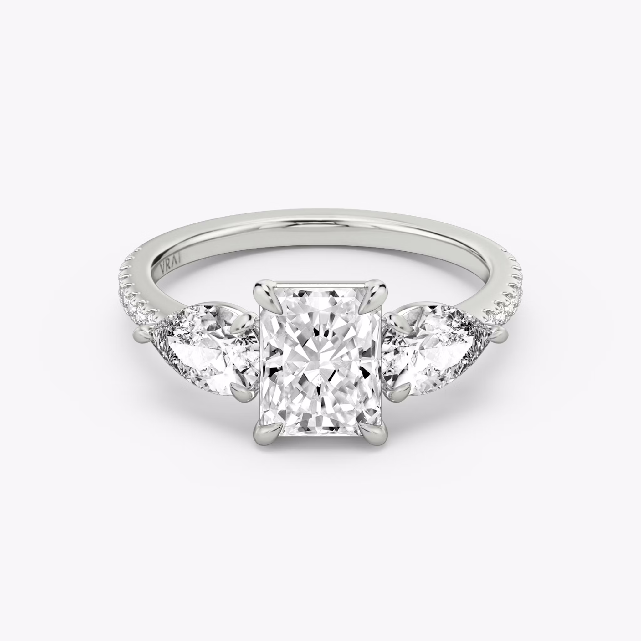 The Three Stone | Radiant | 18k | White Gold | bandAccent: Pavé | sideStoneCarat: 0.50ct | sideStoneShape: Pear | diamondOrientation: vertical | caratWeight: other