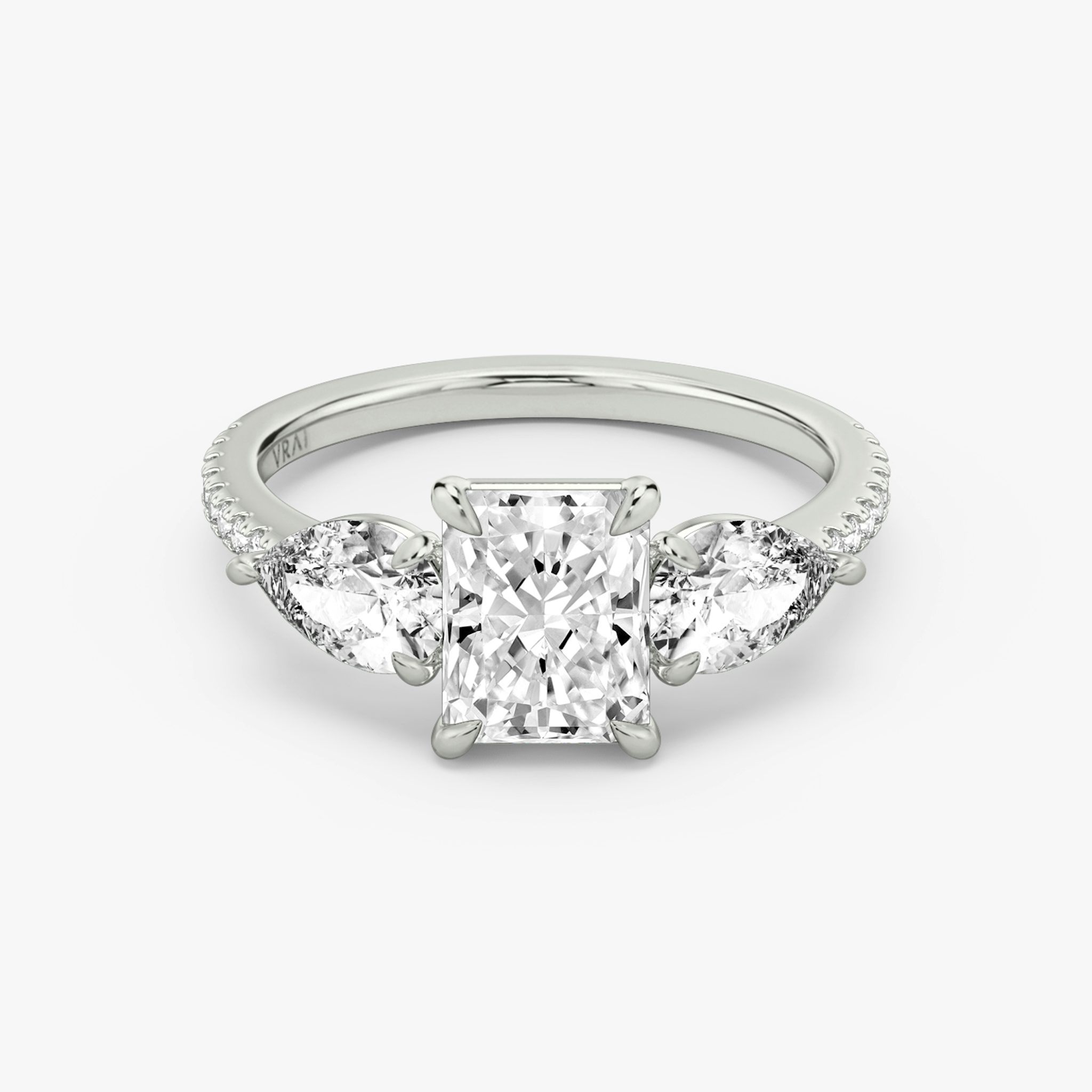 The Three Stone | Radiant | 18k | White Gold | bandAccent: Pavé | sideStoneCarat: 0.50ct | sideStoneShape: Pear | diamondOrientation: vertical | caratWeight: other