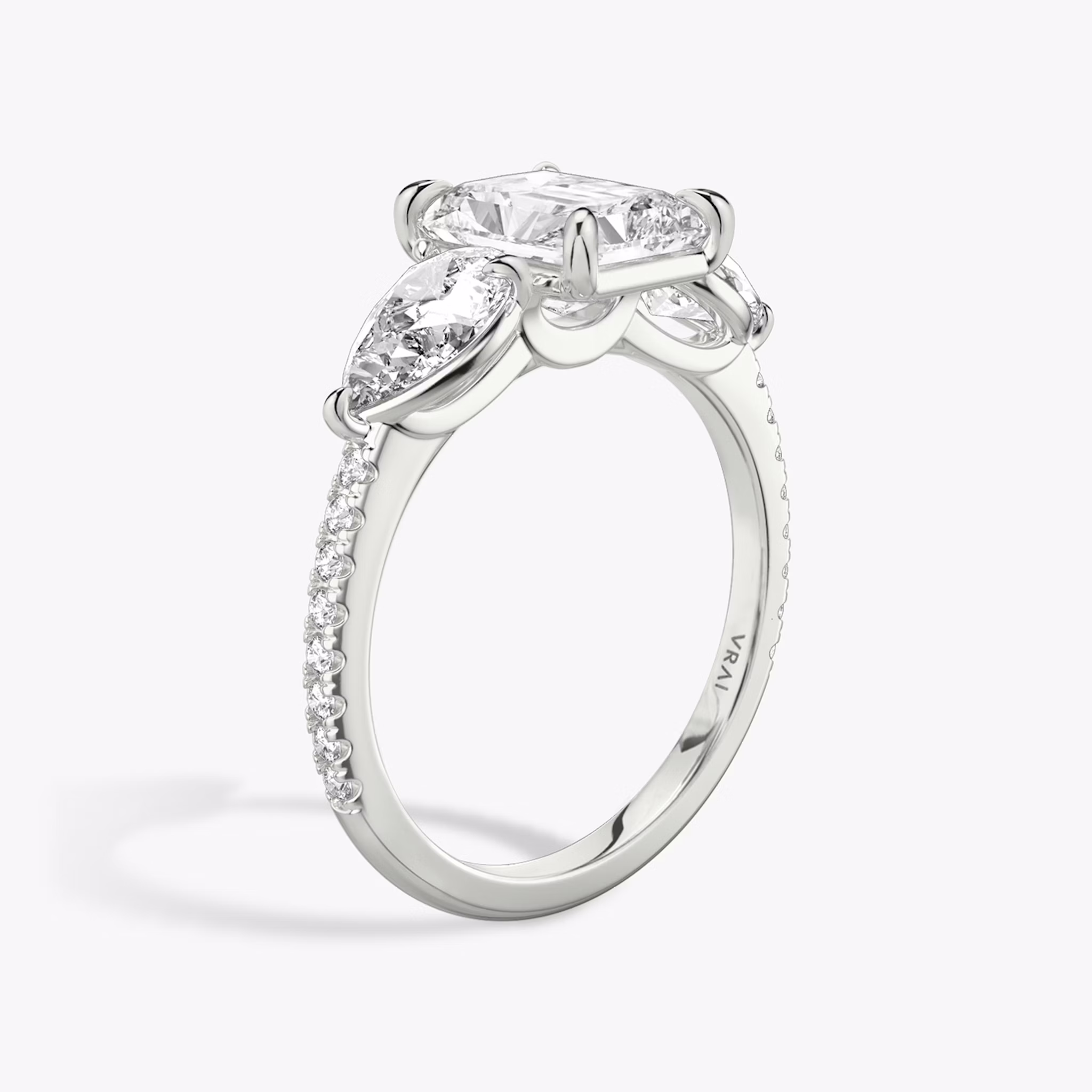 The Three Stone | Radiant | 18k | White Gold | bandAccent: Pavé | sideStoneCarat: 0.50ct | sideStoneShape: Pear | diamondOrientation: vertical | caratWeight: other
