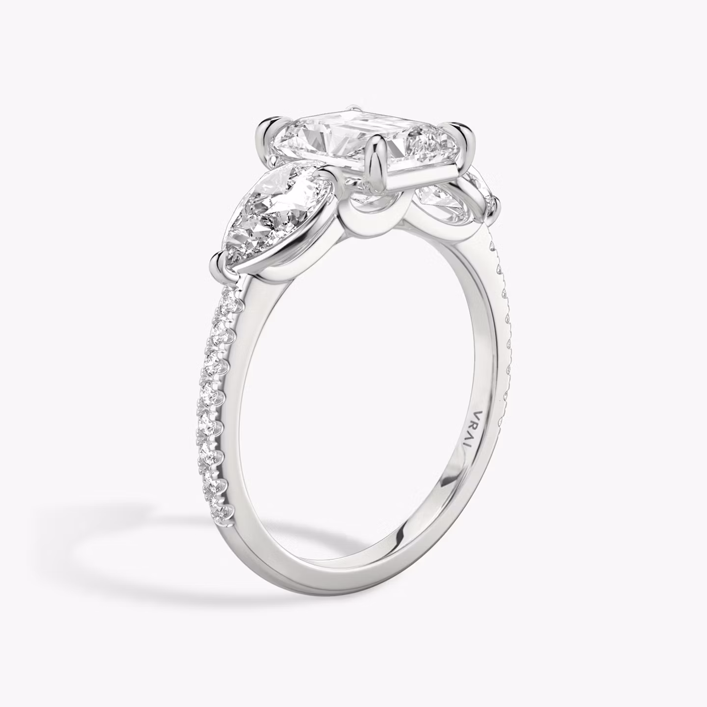 The Three Stone | Radiant | 18k | White Gold | bandAccent: Pavé | sideStoneCarat: 0.50ct | sideStoneShape: Pear | diamondOrientation: vertical | caratWeight: other