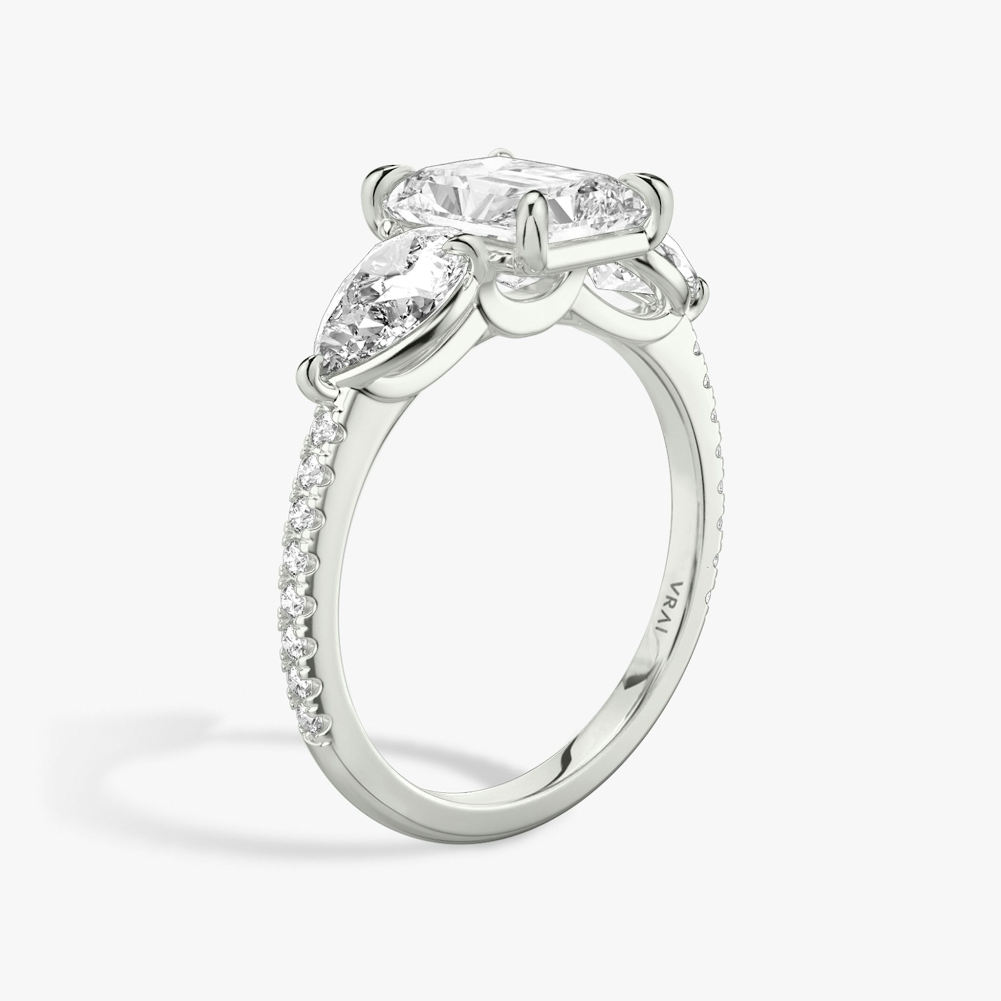 The Three Stone | Radiant | 18k | White Gold | bandAccent: Pavé | sideStoneCarat: 0.50ct | sideStoneShape: Pear | diamondOrientation: vertical | caratWeight: other