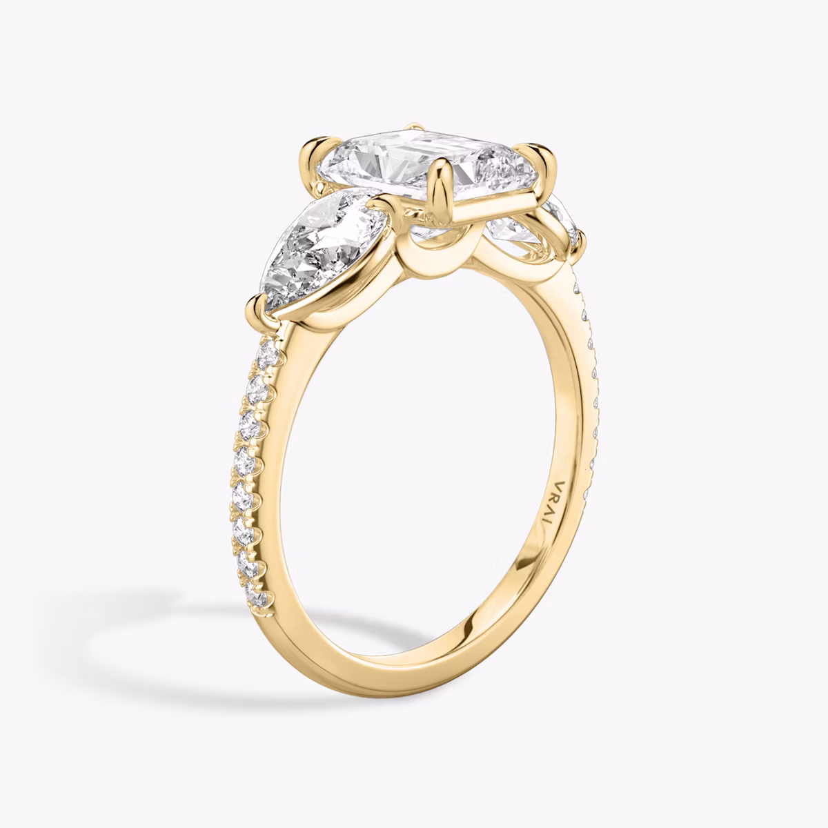 The Three Stone | Radiant | 18k | Yellow Gold | bandAccent: Pavé | sideStoneCarat: 0.50ct | sideStoneShape: Pear | diamondOrientation: vertical | caratWeight: other