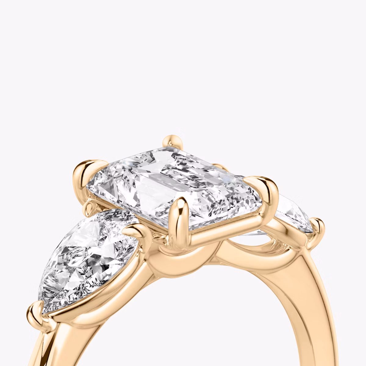 The Three Stone | Radiant | 14k | Rose Gold | bandAccent: Plain | sideStoneCarat: 0.50ct | sideStoneShape: Pear | diamondOrientation: vertical | caratWeight: other