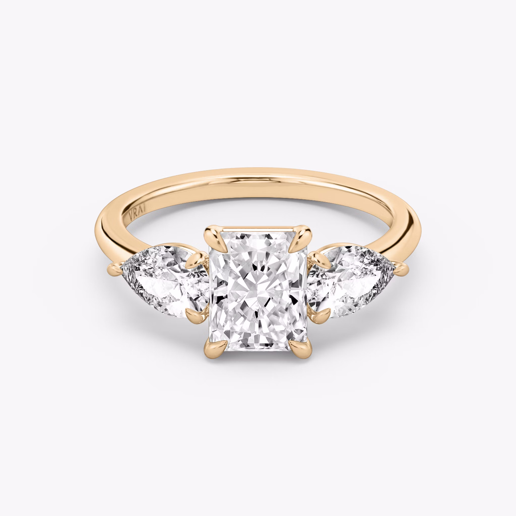 The Three Stone | Radiant | 14k | Rose Gold | bandAccent: Plain | sideStoneCarat: 0.50ct | sideStoneShape: Pear | diamondOrientation: vertical | caratWeight: other