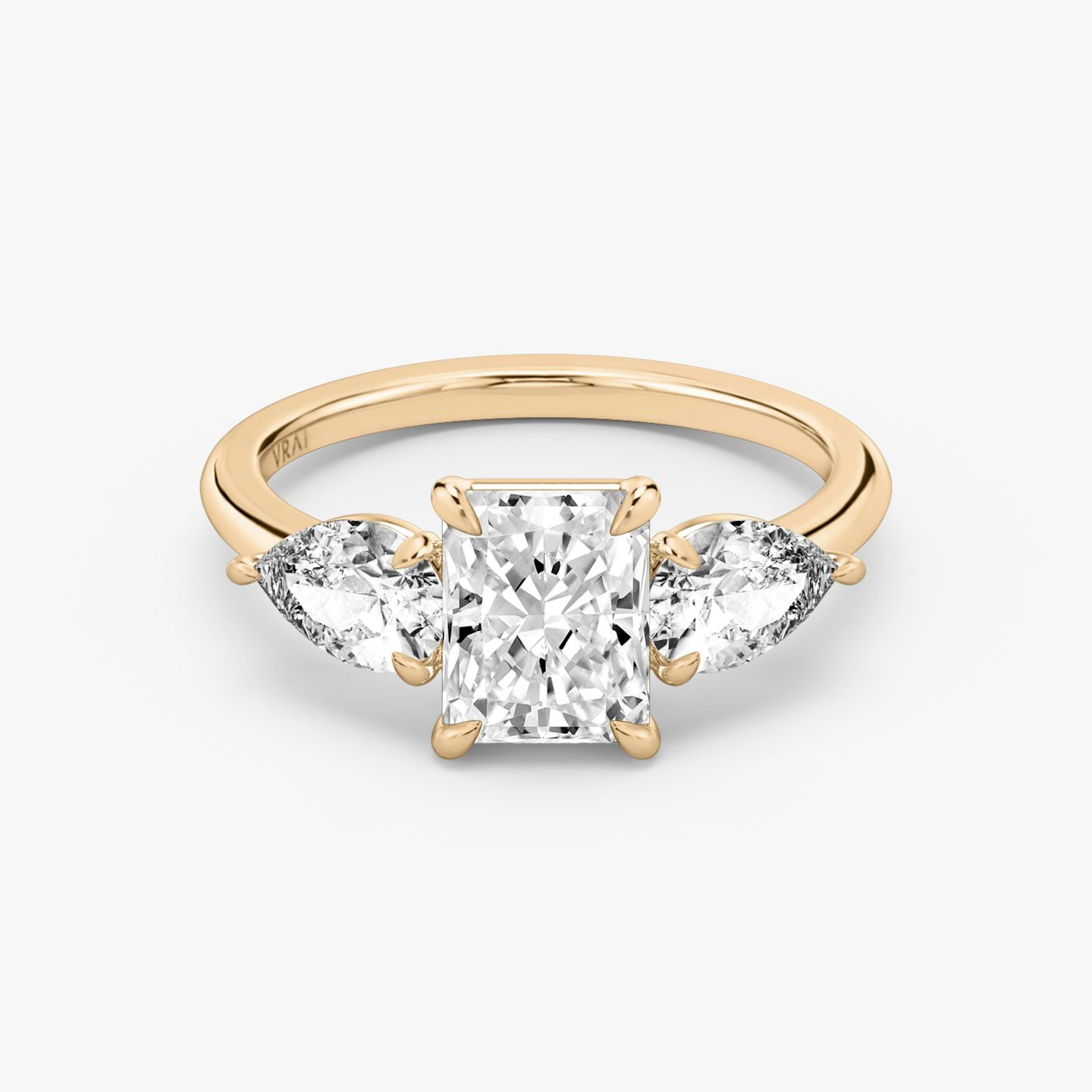 The Three Stone | Radiant | 14k | Rose Gold | bandAccent: Plain | sideStoneCarat: 0.50ct | sideStoneShape: Pear | diamondOrientation: vertical | caratWeight: other