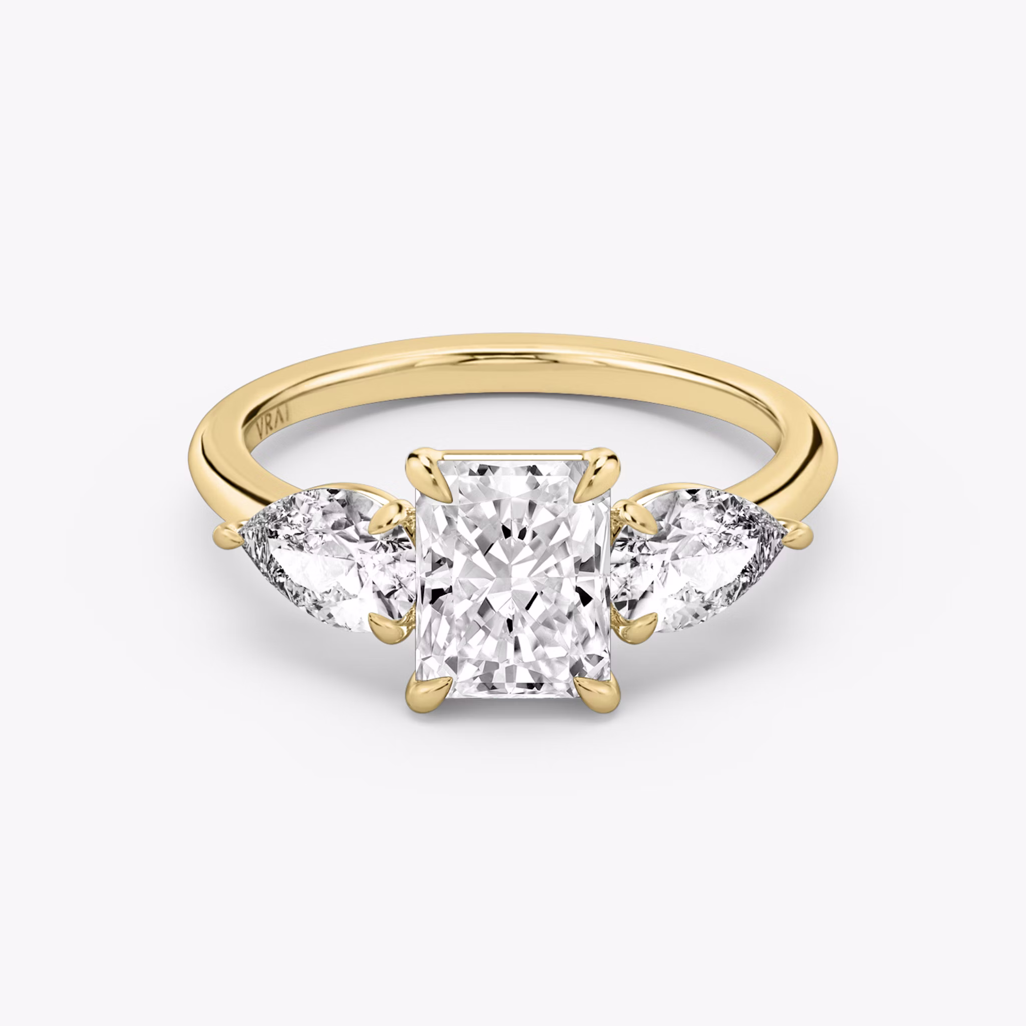 The Three Stone | Radiant | 18k | Yellow Gold | bandAccent: Plain | sideStoneCarat: 0.50ct | sideStoneShape: Pear | diamondOrientation: vertical | caratWeight: other