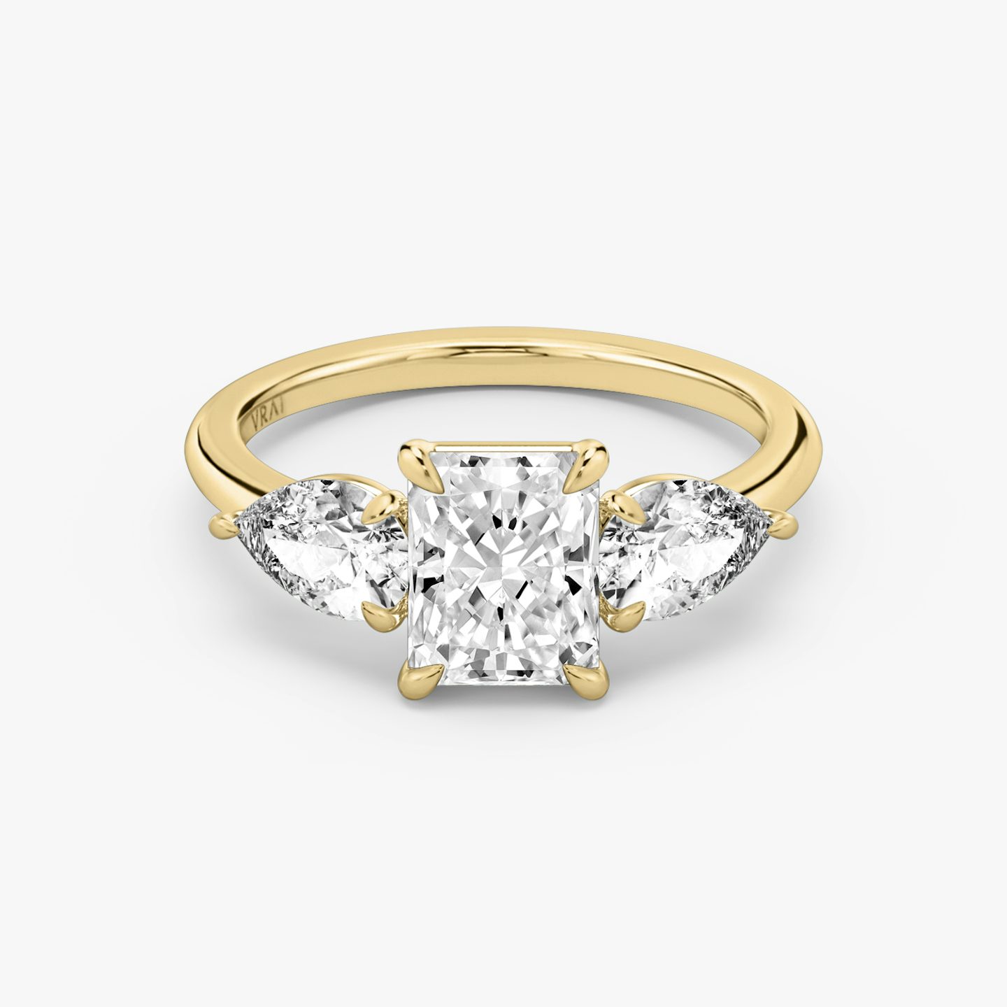 The Three Stone | Radiant | 18k | Yellow Gold | bandAccent: Plain | sideStoneCarat: 0.50ct | sideStoneShape: Pear | diamondOrientation: vertical | caratWeight: other