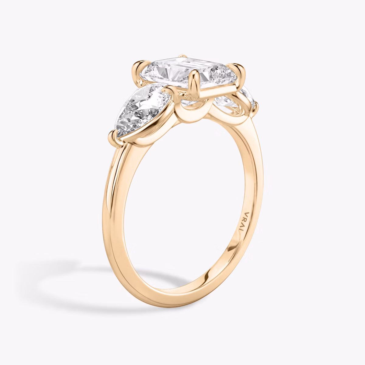 The Three Stone | Radiant | 14k | Rose Gold | bandAccent: Plain | sideStoneCarat: 0.50ct | sideStoneShape: Pear | diamondOrientation: vertical | caratWeight: other