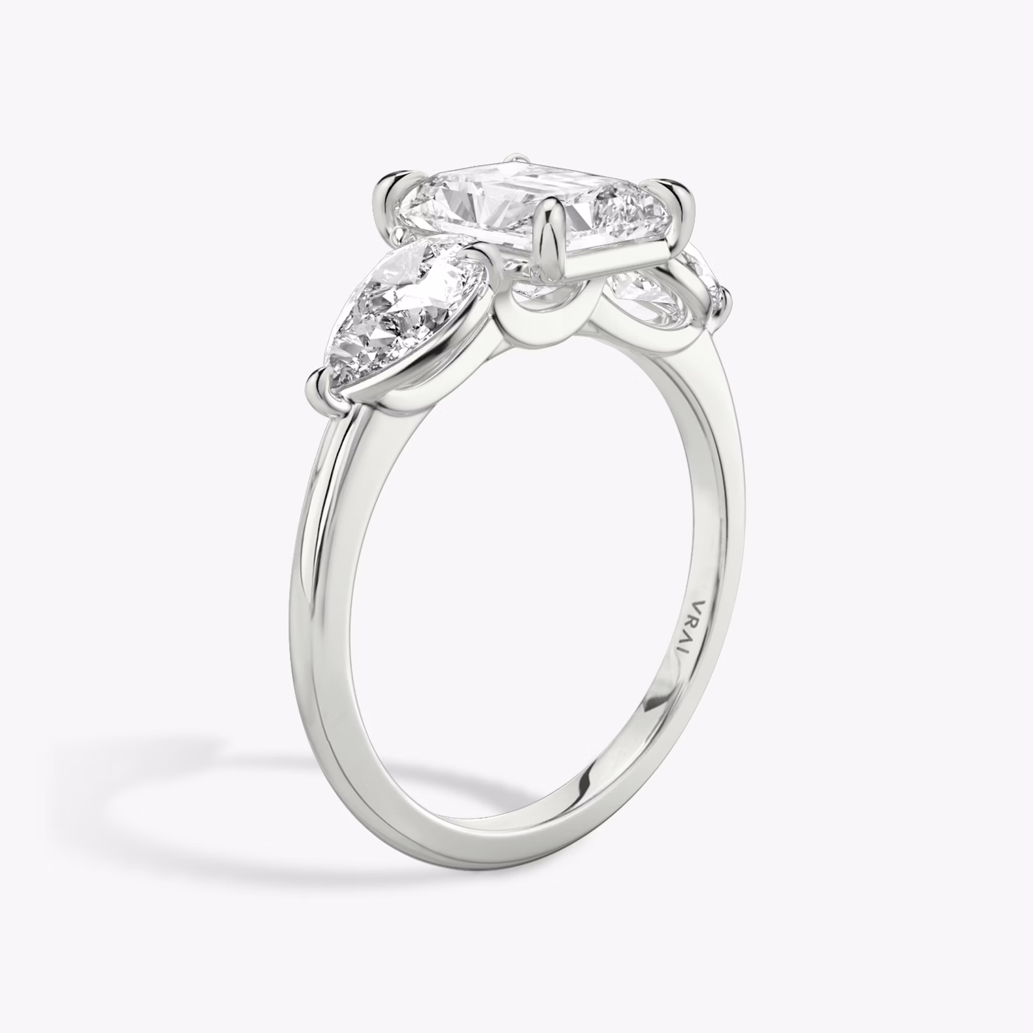 The Three Stone | Radiant | 18k | White Gold | bandAccent: Plain | sideStoneCarat: 0.50ct | sideStoneShape: Pear | diamondOrientation: vertical | caratWeight: other