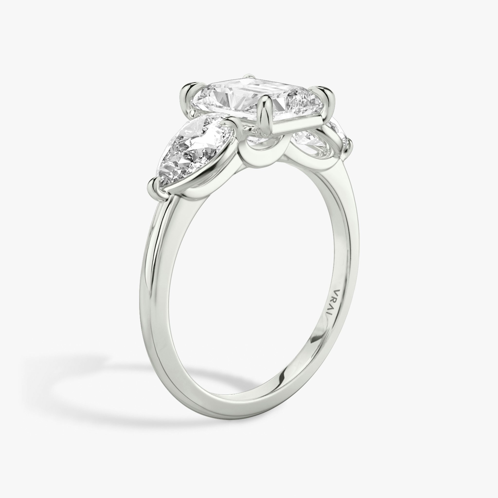 The Three Stone | Radiant | 18k | White Gold | bandAccent: Plain | sideStoneCarat: 0.50ct | sideStoneShape: Pear | diamondOrientation: vertical | caratWeight: other