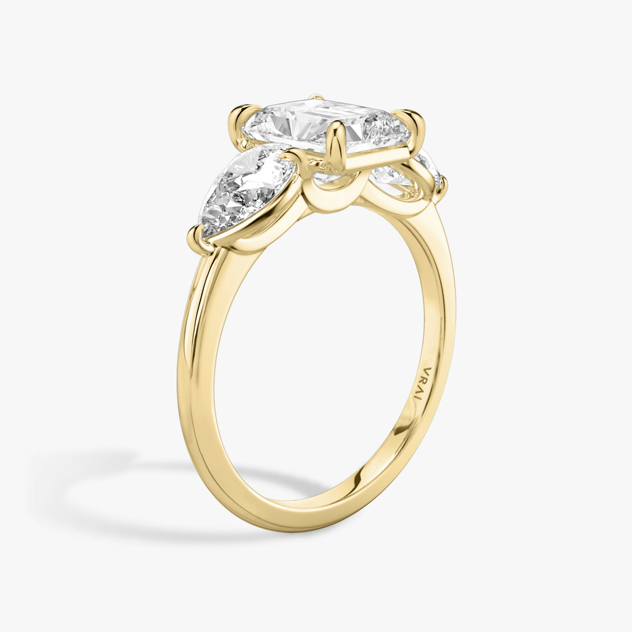 The Three Stone | Radiant | 18k | Yellow Gold | bandAccent: Plain | sideStoneCarat: 0.50ct | sideStoneShape: Pear | diamondOrientation: vertical | caratWeight: other
