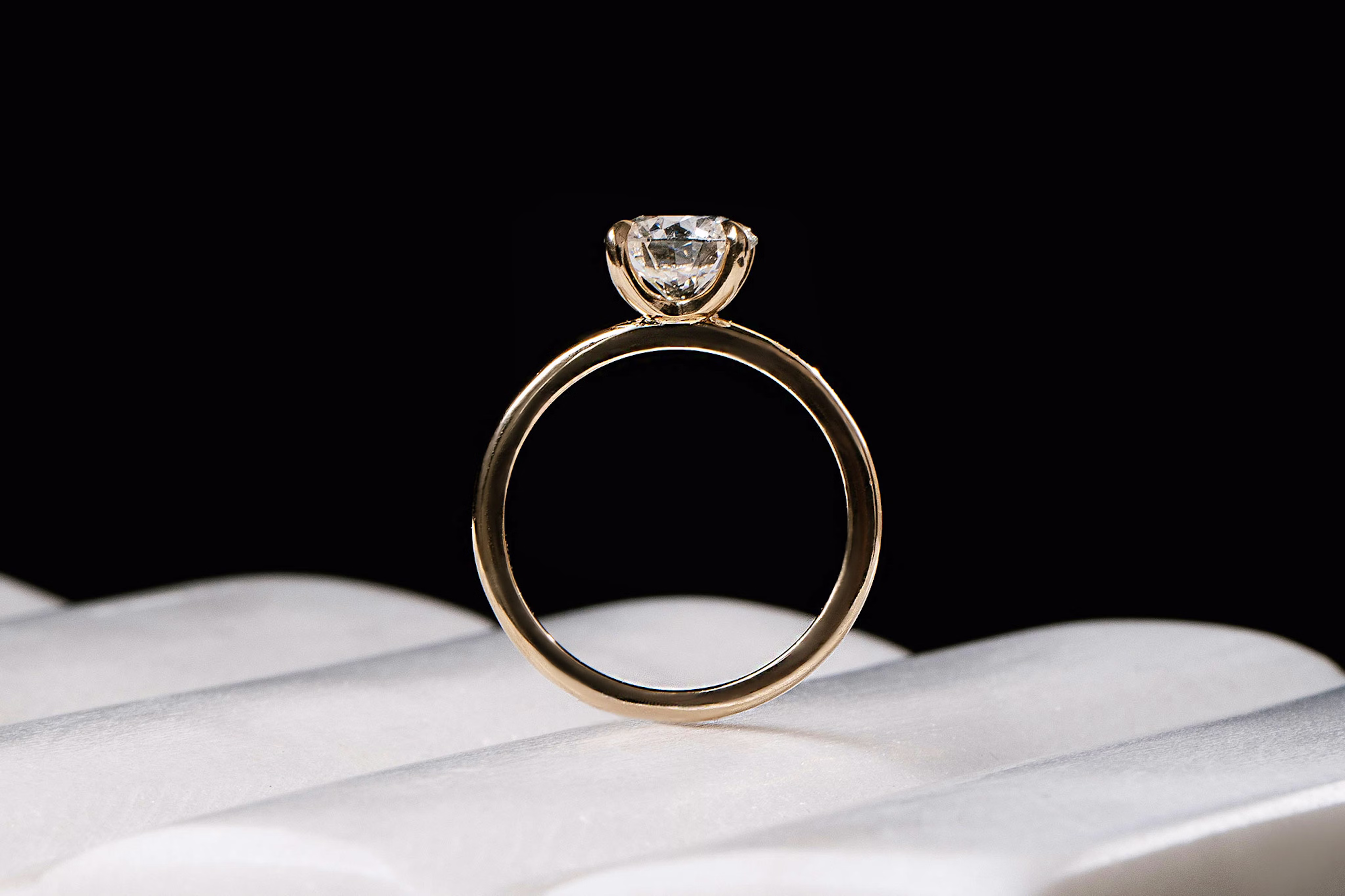 The classic round brilliant engagement ring with yellow gold band