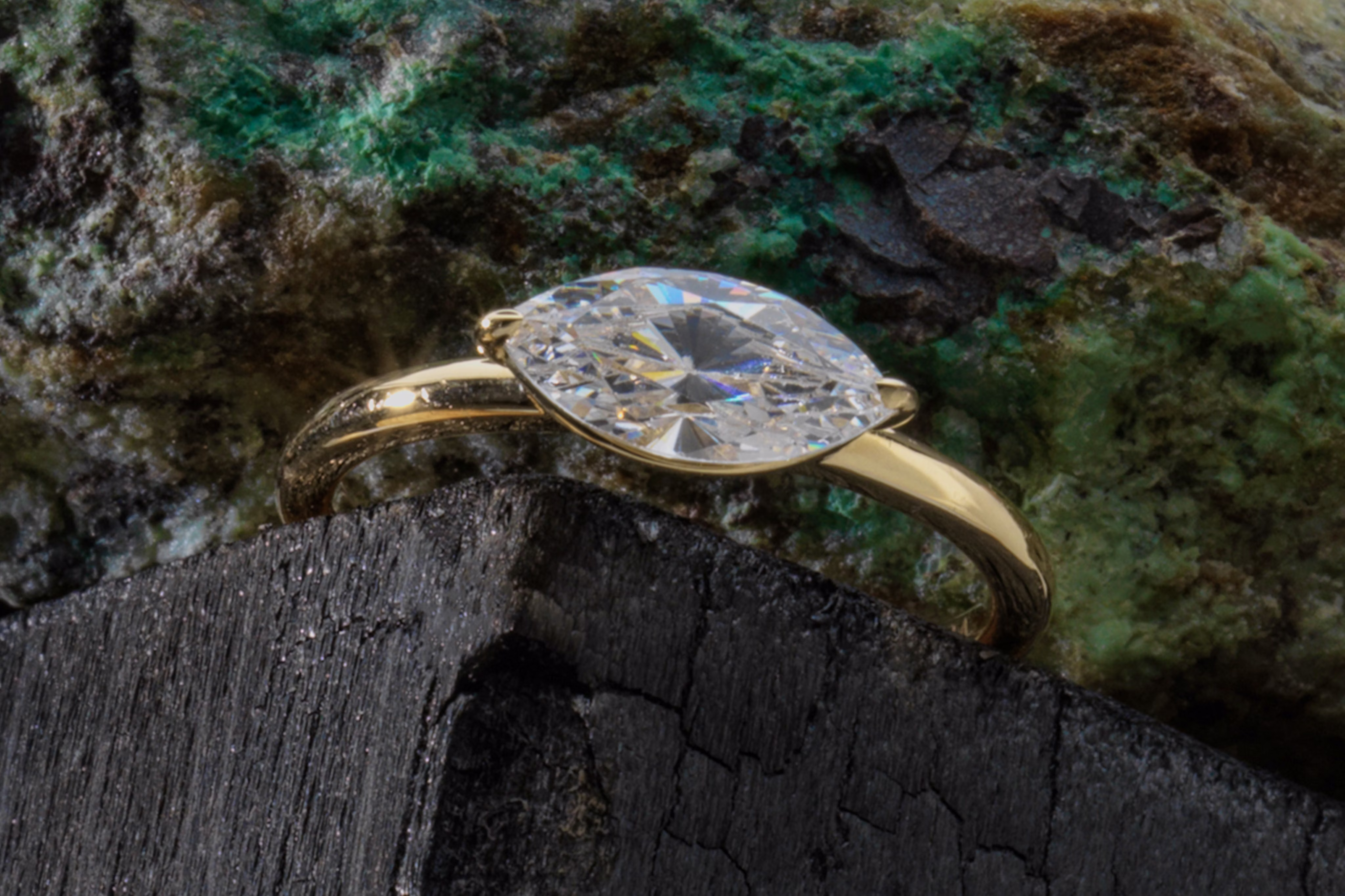 The marquise signature east west engagement ring with yellow gold band