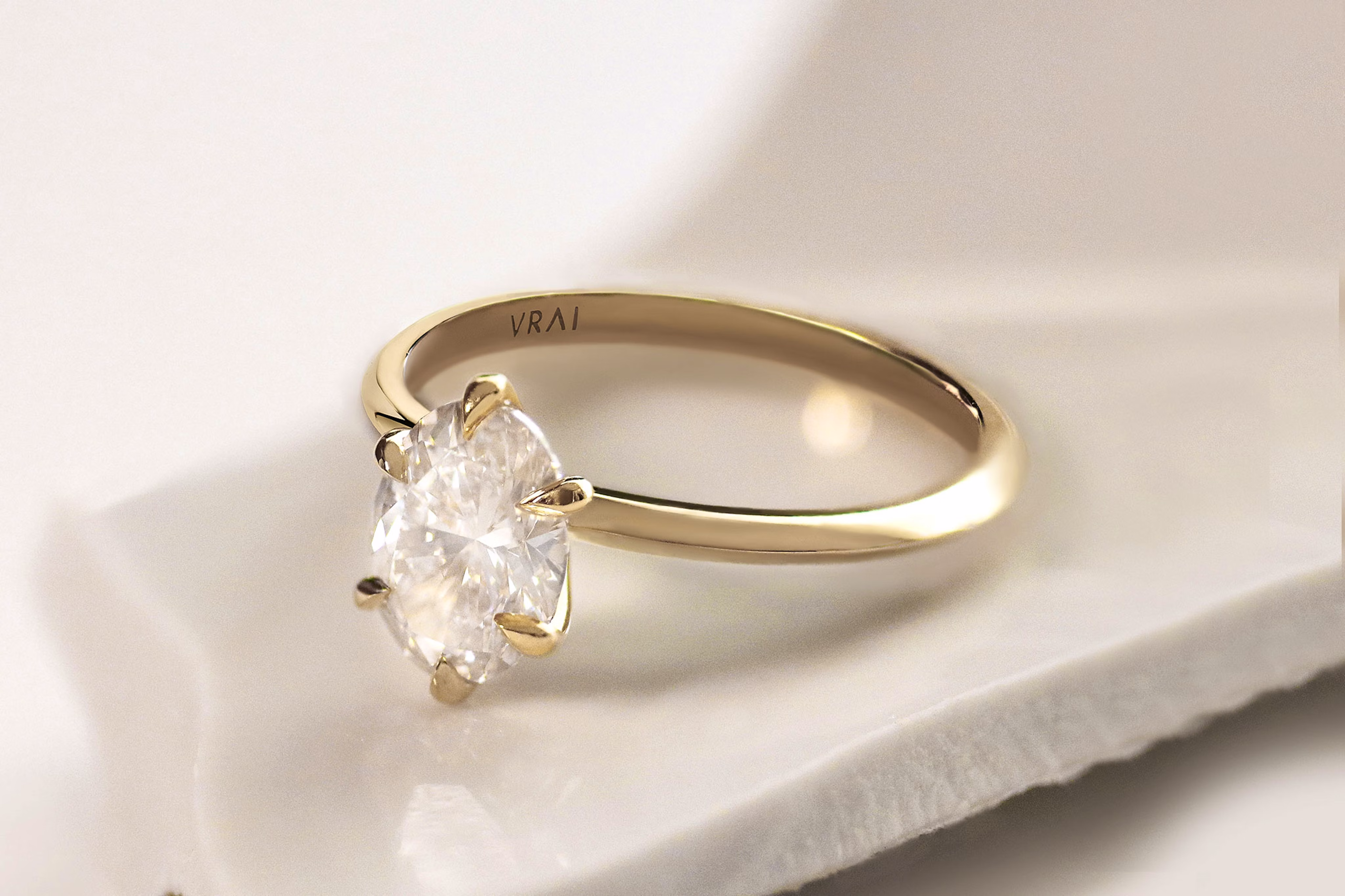 The oval knife edge engagement ring with yellow gold band