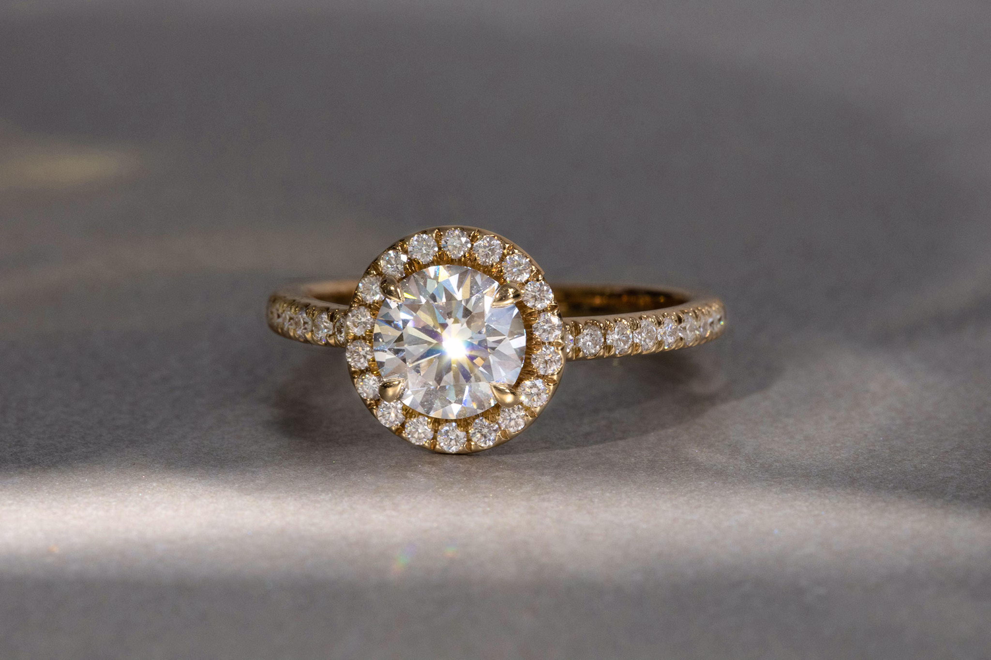 the round brilliant halo engagement ring with yellow gold pave band