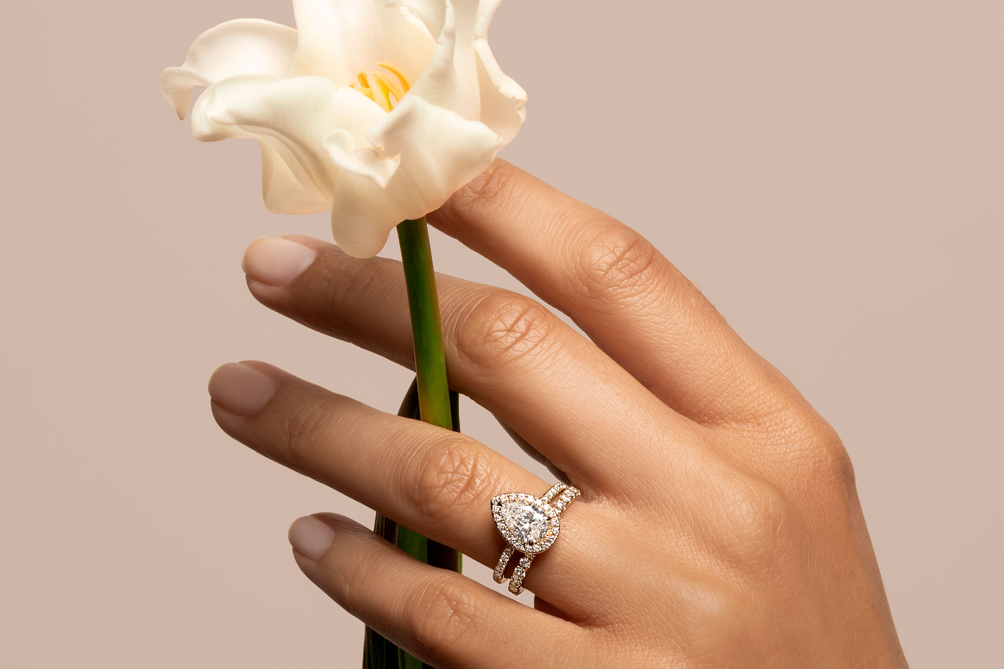 The pear halo engagement ring with yellow gold pave band 