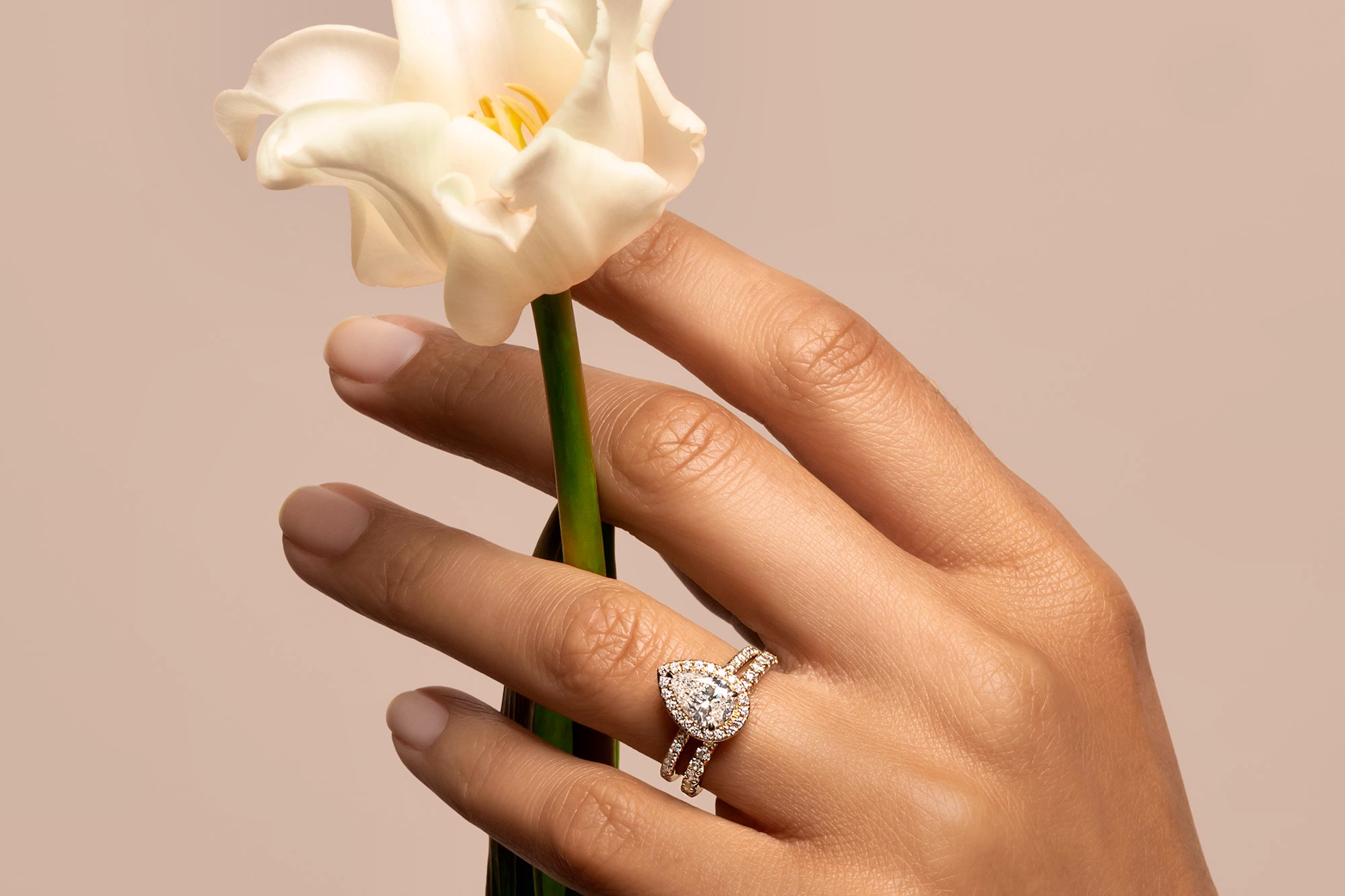 The pear halo engagement ring with yellow gold pave band