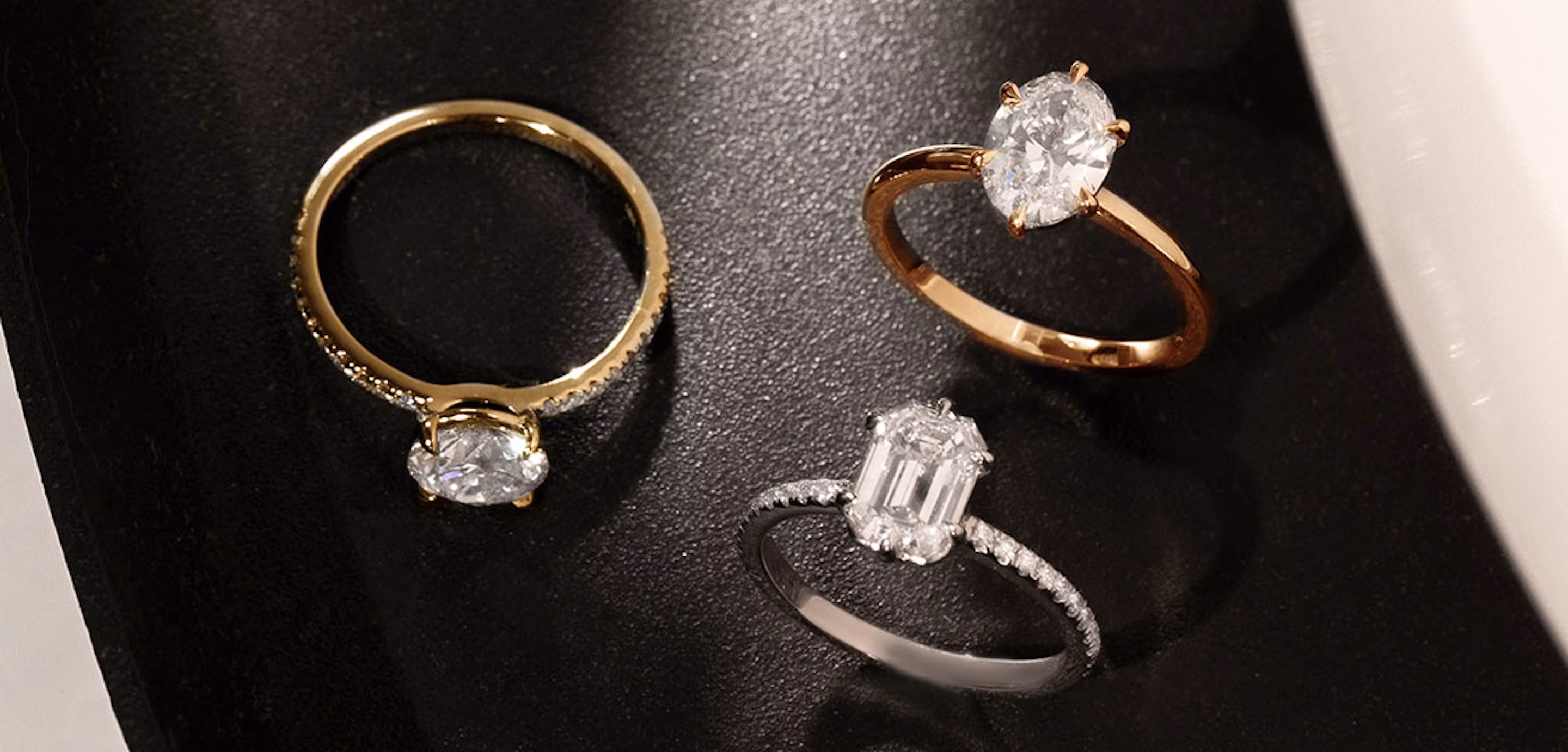 Round brilliant engagement ring with yellow gold pave band, signature 6 prong oval engagement ring with rose gold pave band, signature emerald engagement ring with white gold pave band