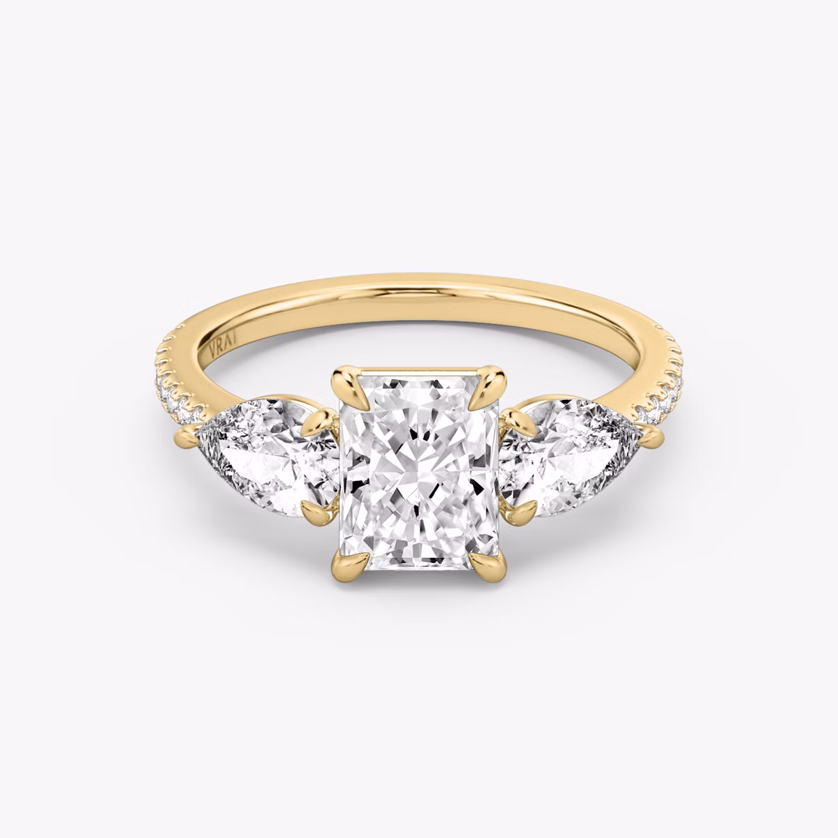 The Three Stone | Radiant | 18k | Yellow Gold | bandAccent: Pavé | sideStoneCarat: 0.50ct | sideStoneShape: Pear | diamondOrientation: vertical | caratWeight: other