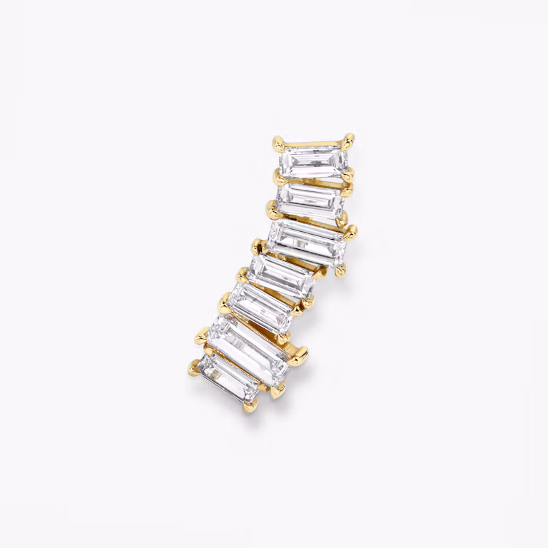 Ear arc made out of solid yellow gold and 7 baguette shaped diamonds