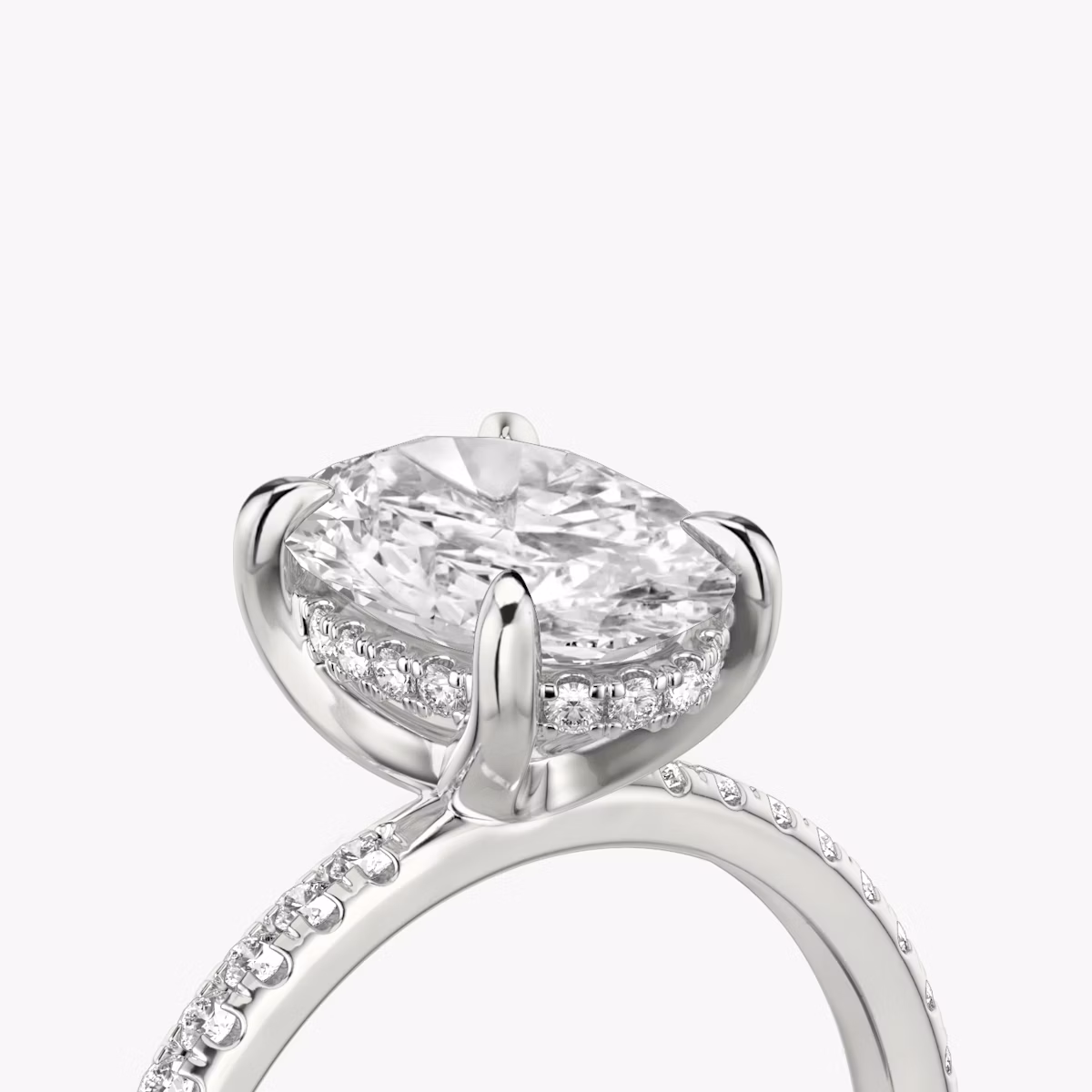 The Classic Hidden Halo | Oval | Platinum | bandAccent: Pavé | bandWidth: standard | prongStyle: Plain | diamondOrientation: vertical | caratWeight: other